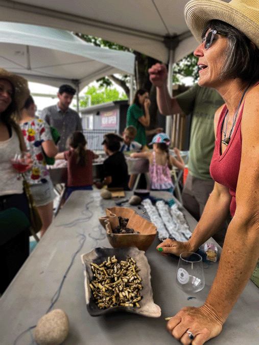 Artist Erika Osborne explains post-fire effects on rivers and helps make bracelets from beads made from clay collected and fired in the Cameron Peak Fire burn scar