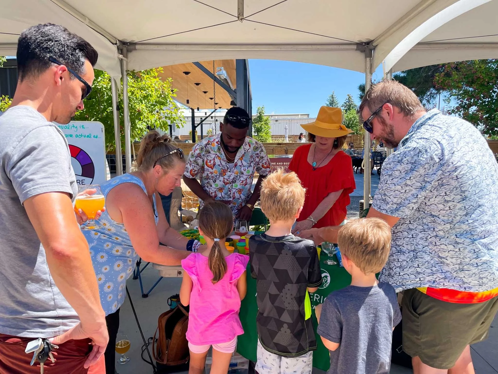 People gathered at a booth to play a game about post-fire air quality