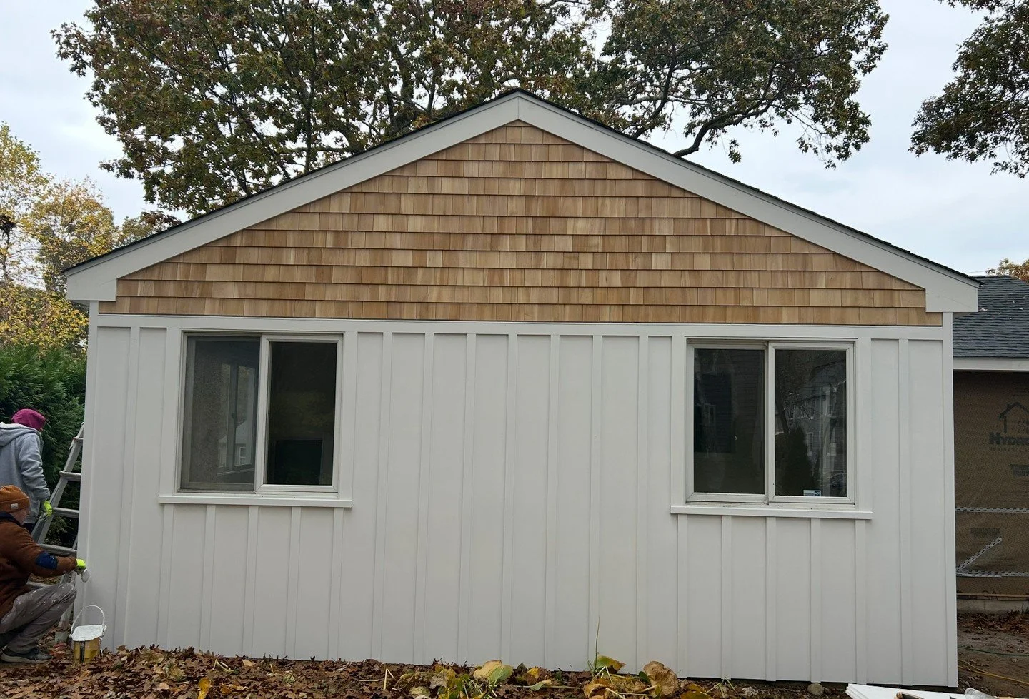 Progress update: @maibecinc cedar shingles are going up, giving this home timeless coastal charm. The sun room detail with Azek board and batten adds a crisp, modern contrast that ties it all together beautifully. Paired with clean trim lines and dur