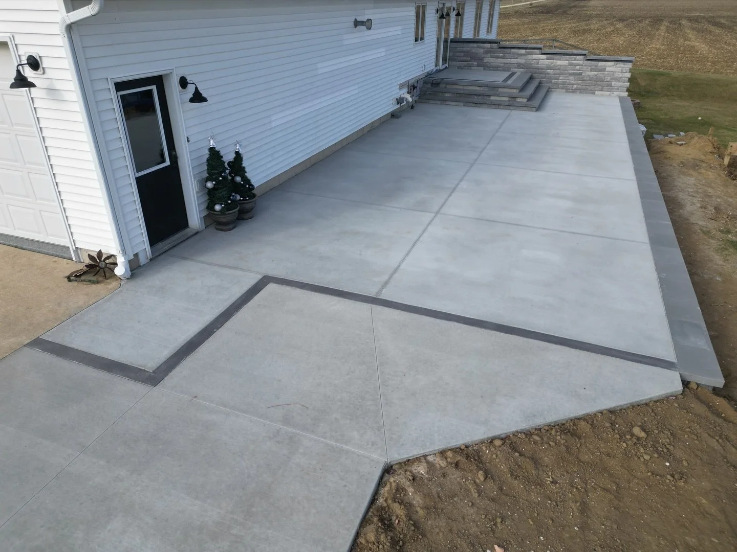 That&rsquo;s a wrap for us on this concrete patio project in Lee County📍 Featuring a traditional broom finish with a inset~border on the stoop, and another border to differentiate the patio from driveway extension. Ready to transform your outdoor li