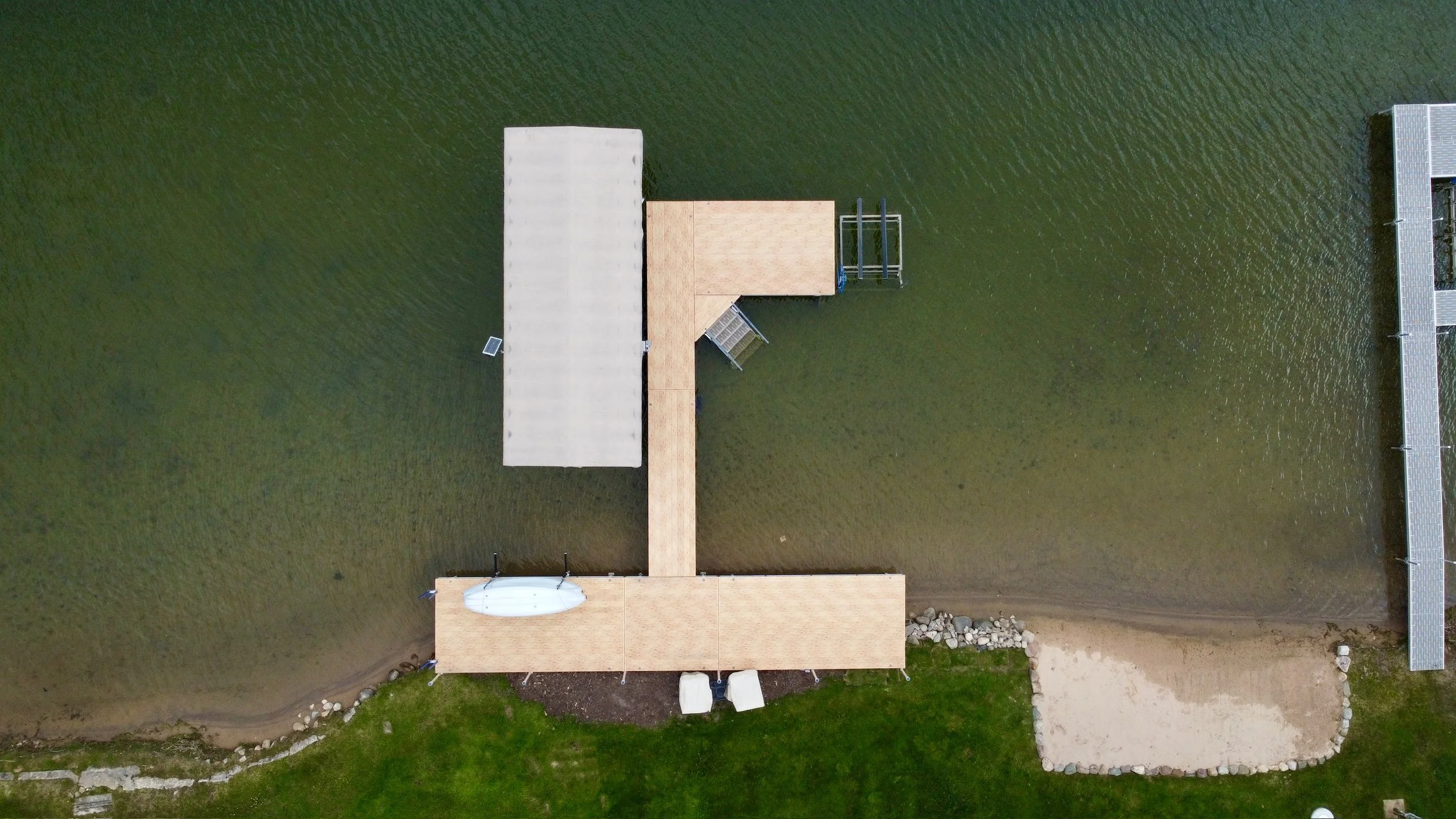 Aluminum dock with boat lift, stairs, and corner section
