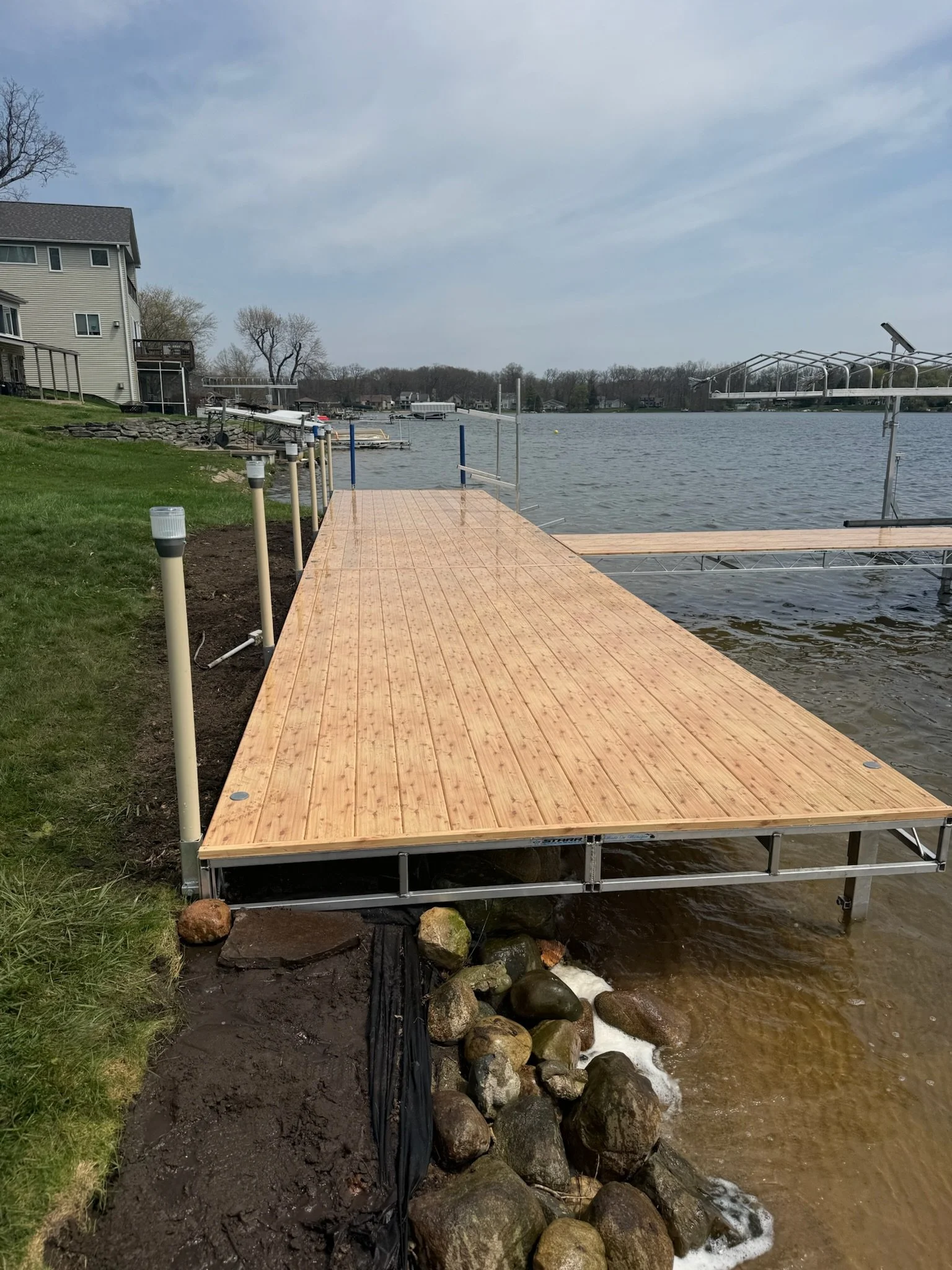 Aluminum dock with solar light post caps 