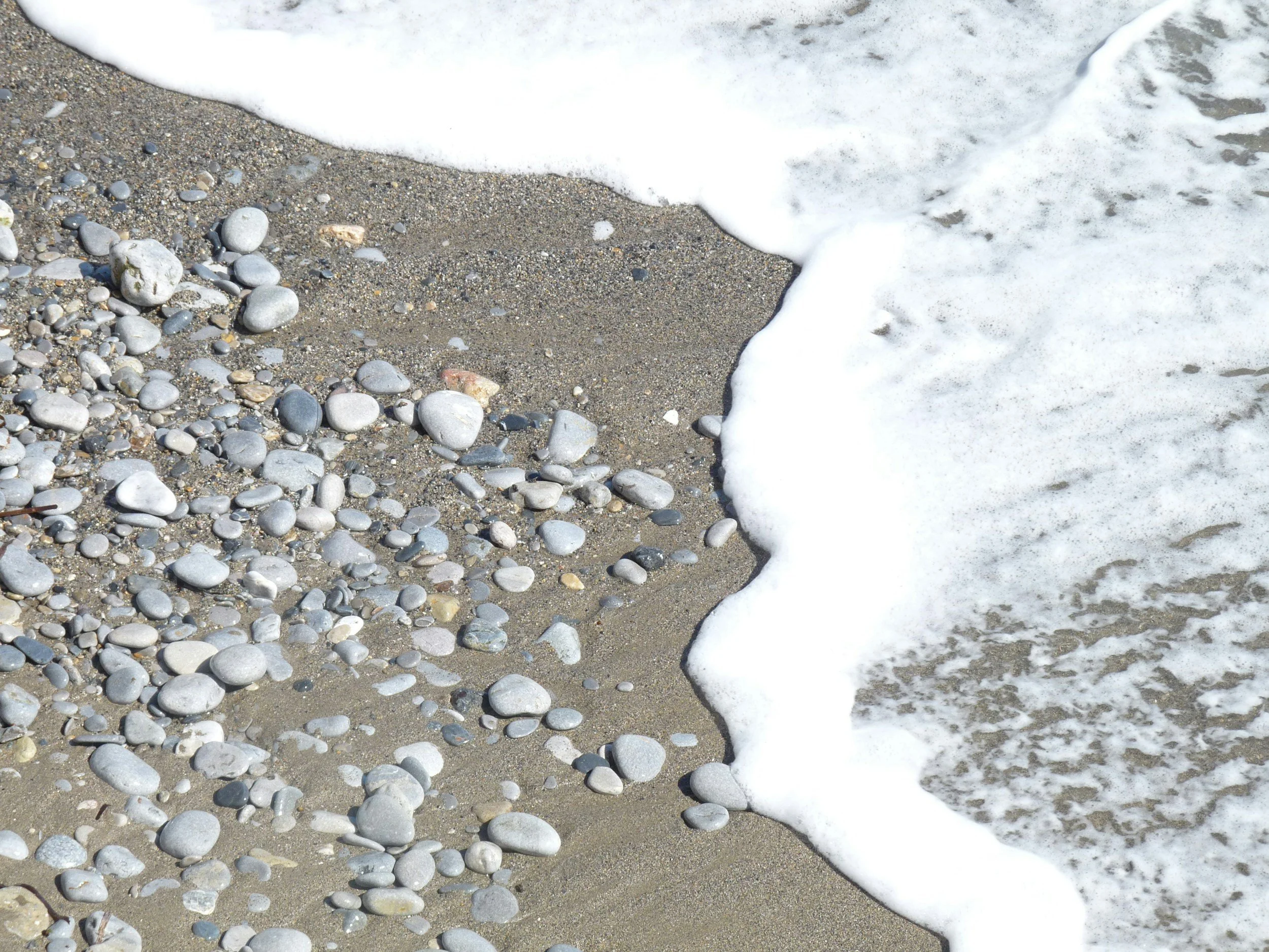 pebbles-on-a-beach-and-waves-