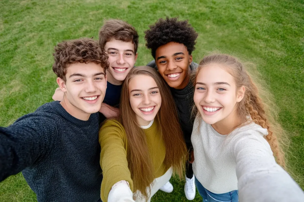 group of teens smiling in a selfie