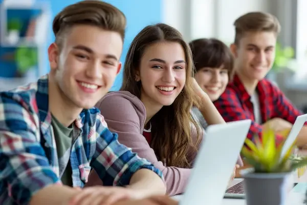 pic of 4 teenagers sitting down near a laptop
