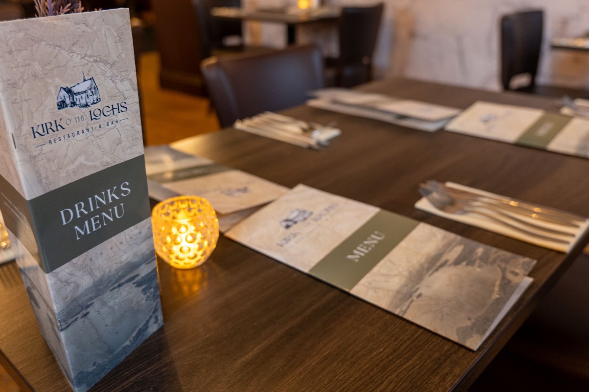 Kirk o'The Lochs restaurant table setup with menus and place settings