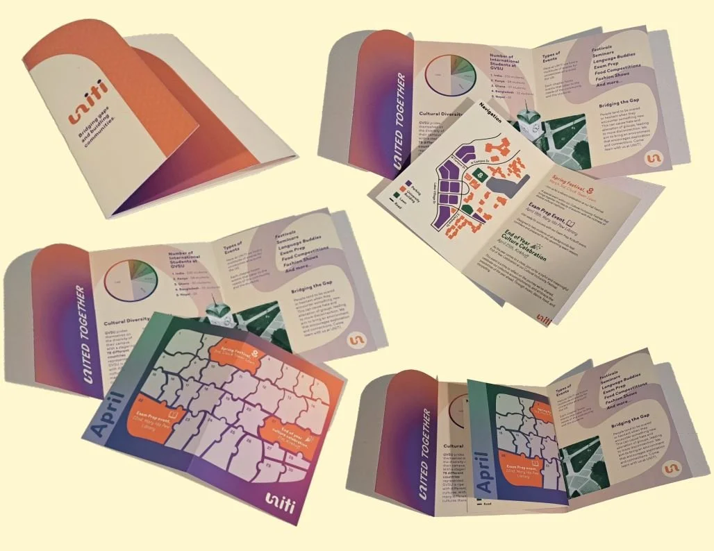 An open brochure with colorful graphics, text, and maps about Unity, cultural diversity, and community events, accompanied by other folded printed materials.