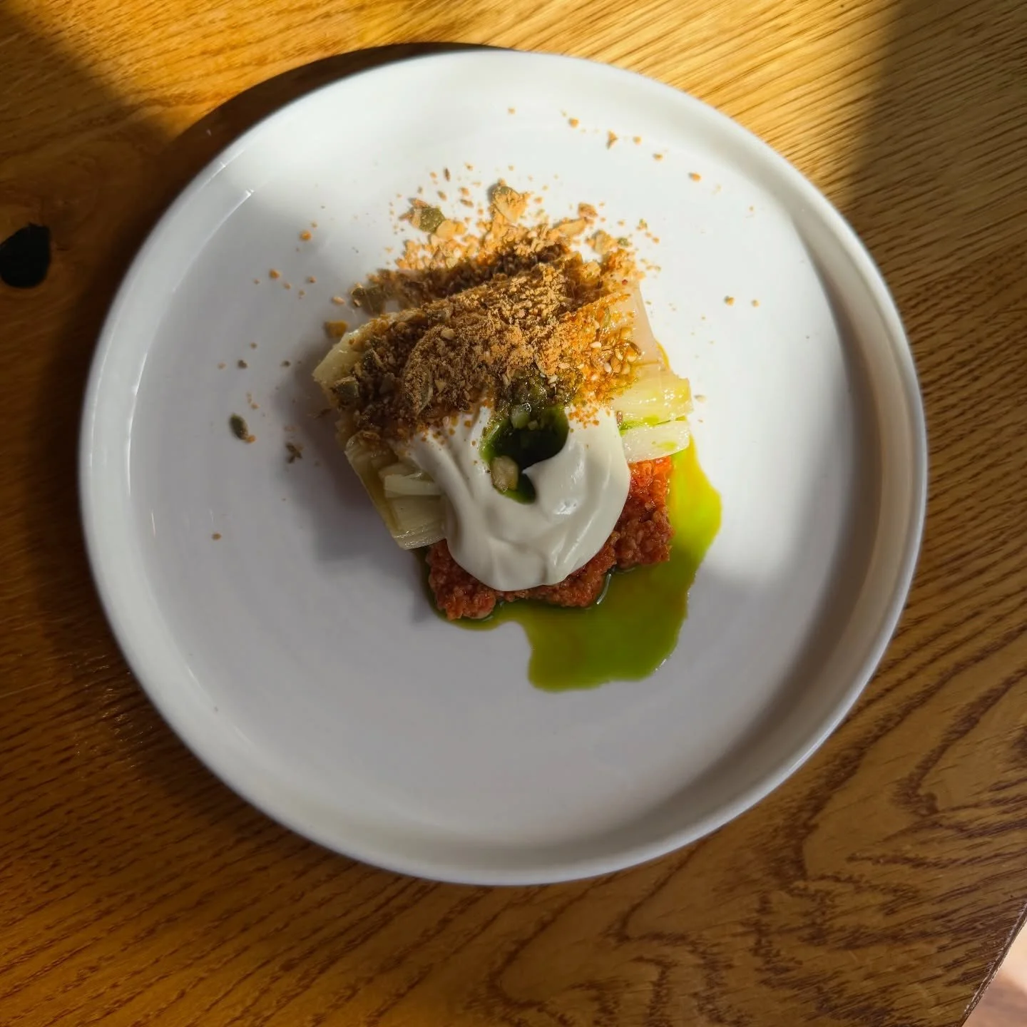 Leeks cooked low and slow in charred leek oil.
Romesco sauce. Cultured cream. Dukkah.

Get stuck in.