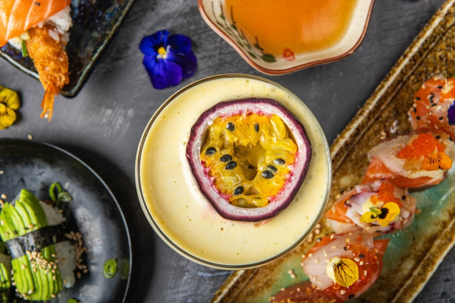 Passion fruit cocktail with colourful sushi and tempura at Sushi & Salad.