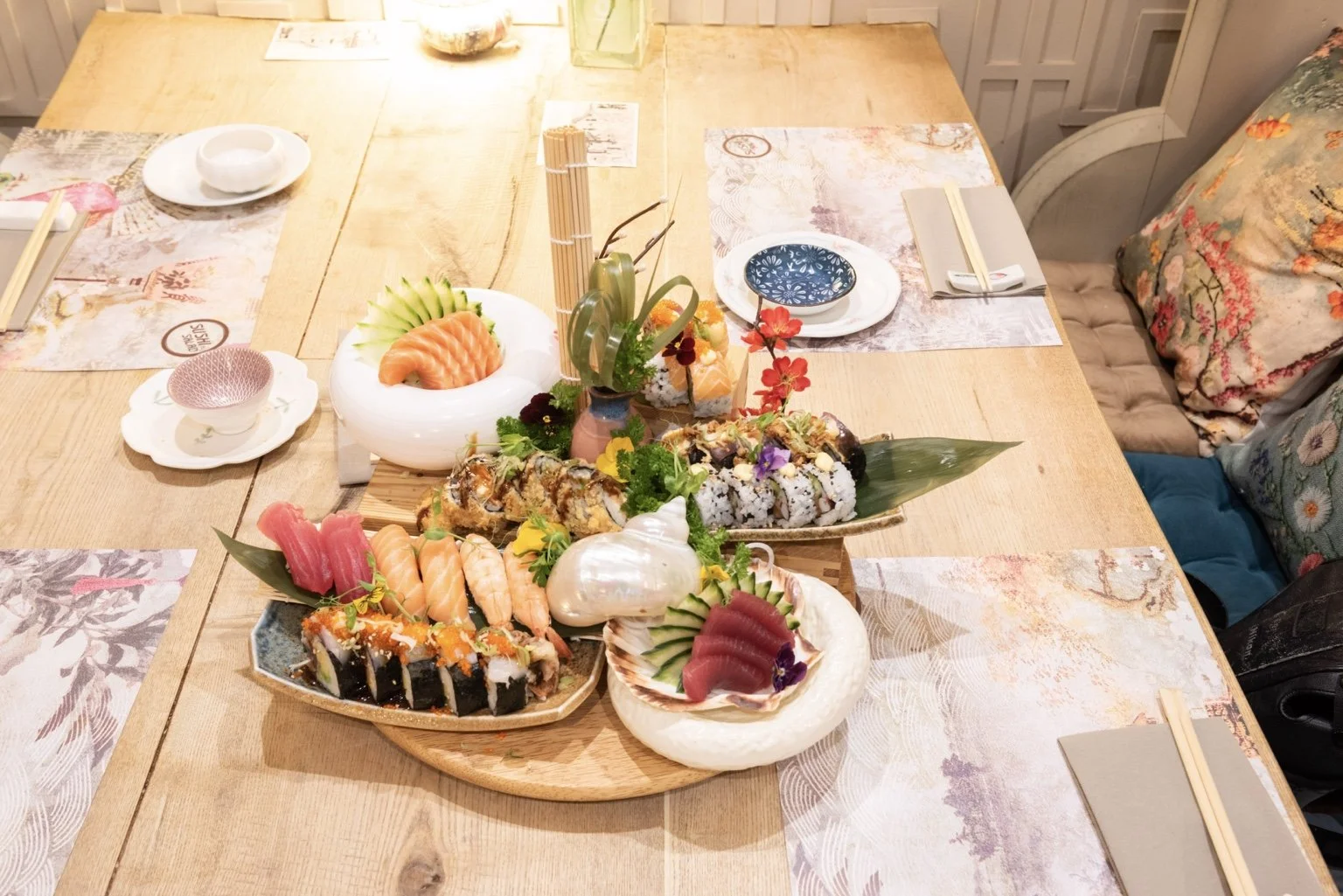 Colourful sushi and sashimi sharing platter presented on a restaurant table.