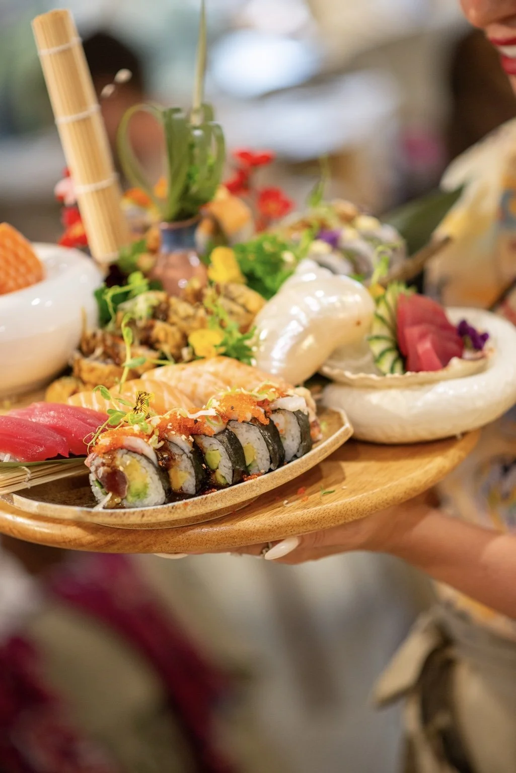 Close-up of a colourful handcrafted sushi and sashimi sharing platter.