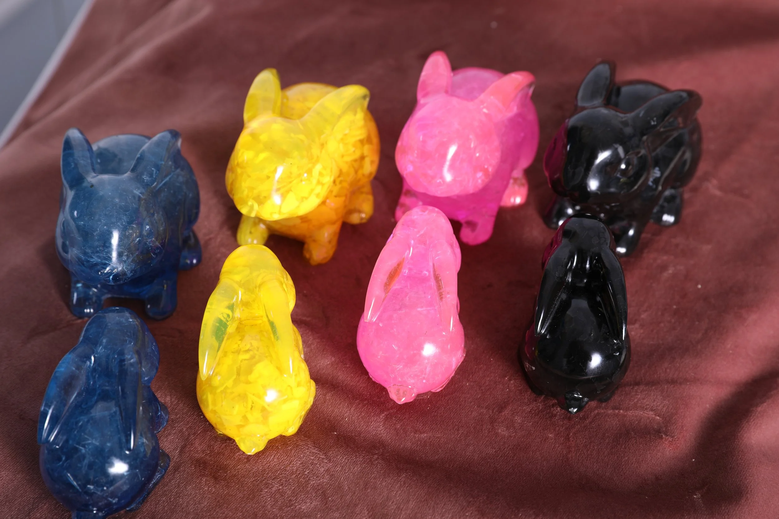 colorful resin bunnies in blue, yellow, pink and black made from upcycled plastic