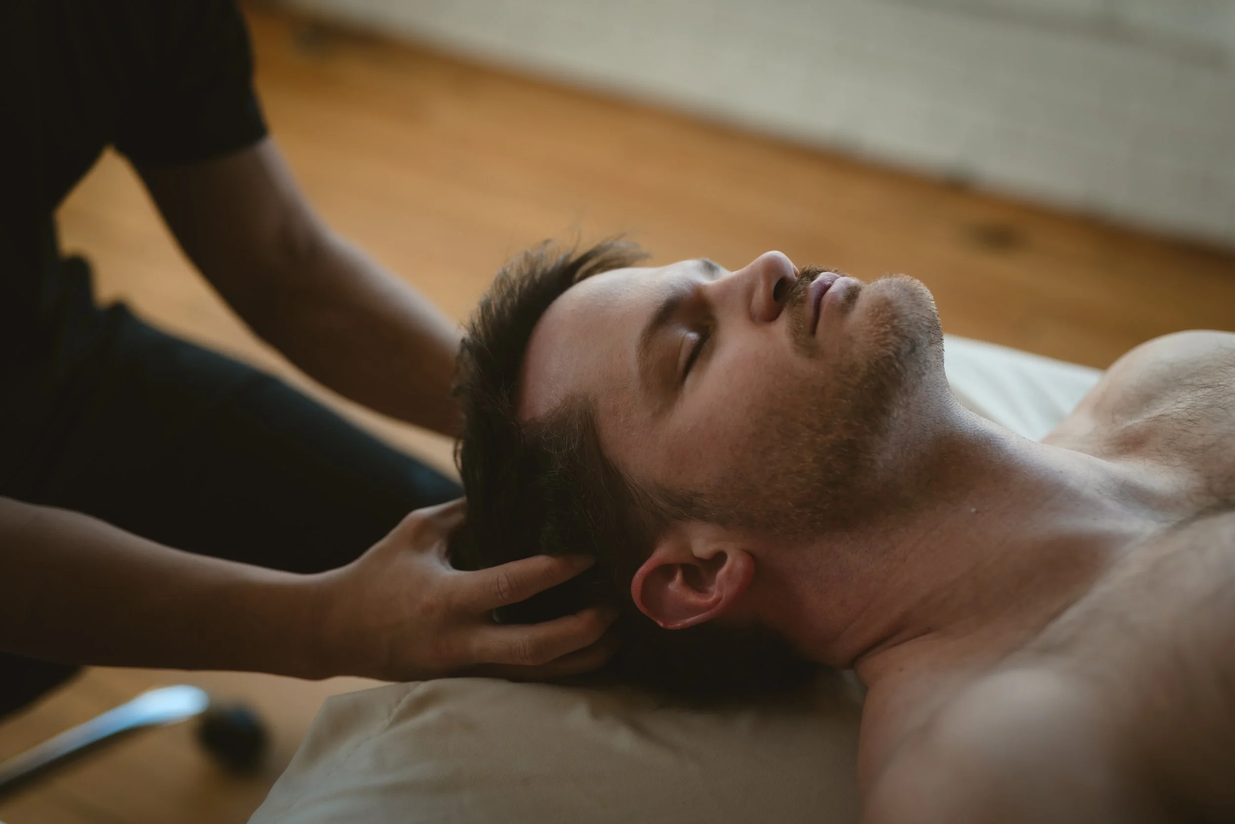 Man getting a head massage looking relaxed