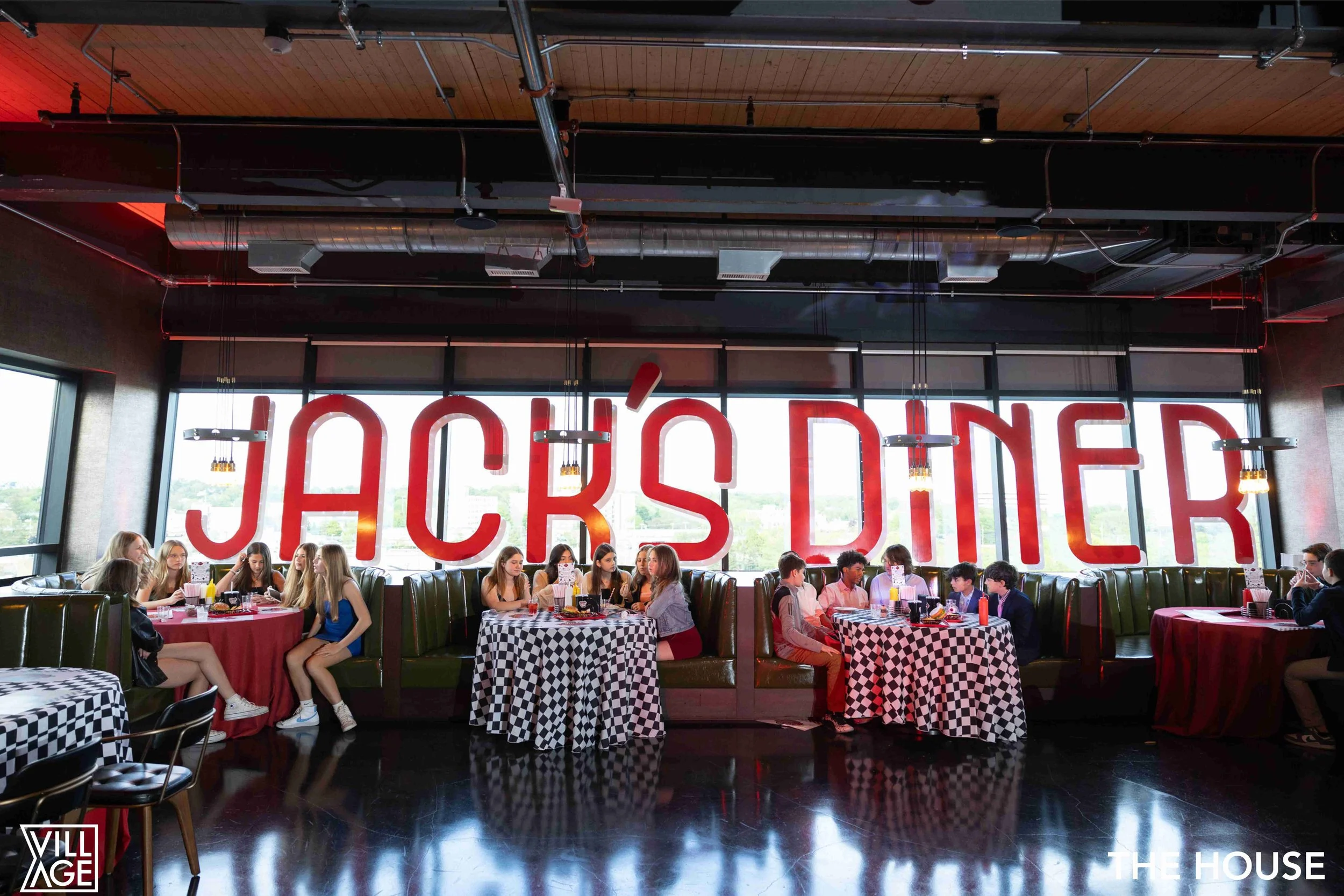 Jack's Diner sign and people sitting at tables with checkered tablecloths