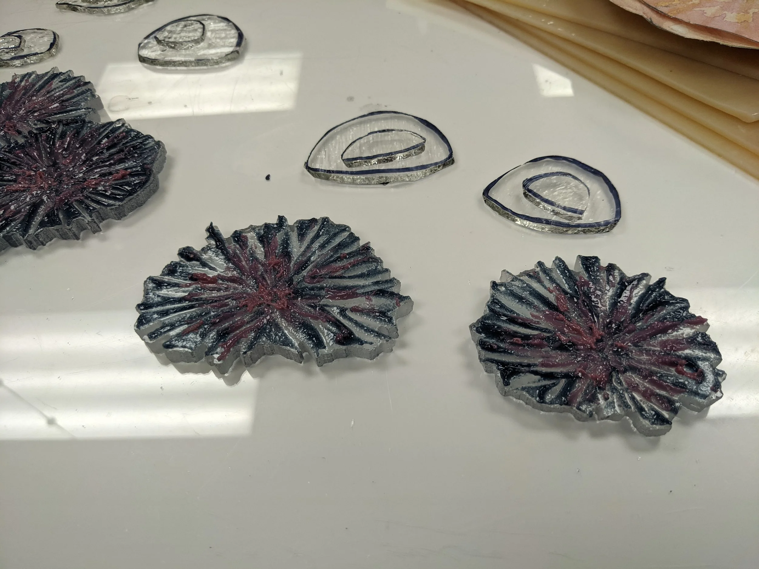 Kristine cut then beveled concentric pieces of tekta to use as a base to fuse the anemones over.