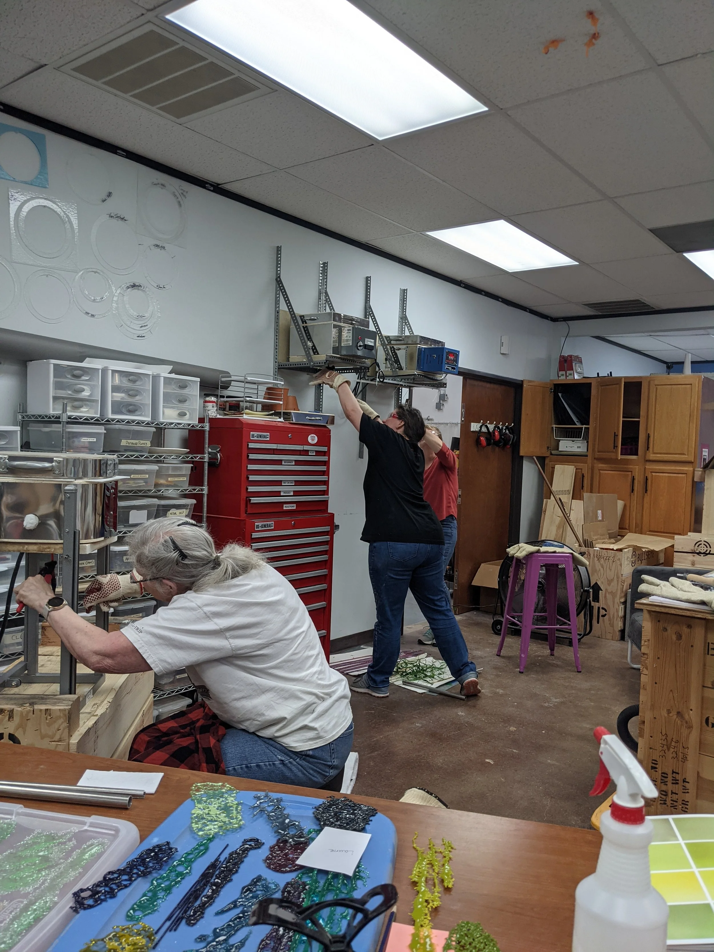 Laurie Rich and Kristine Shafer (and Kathy Thompson working on a private project) pulling vitrigraph stringer. We turn vit pulls into vit parties!