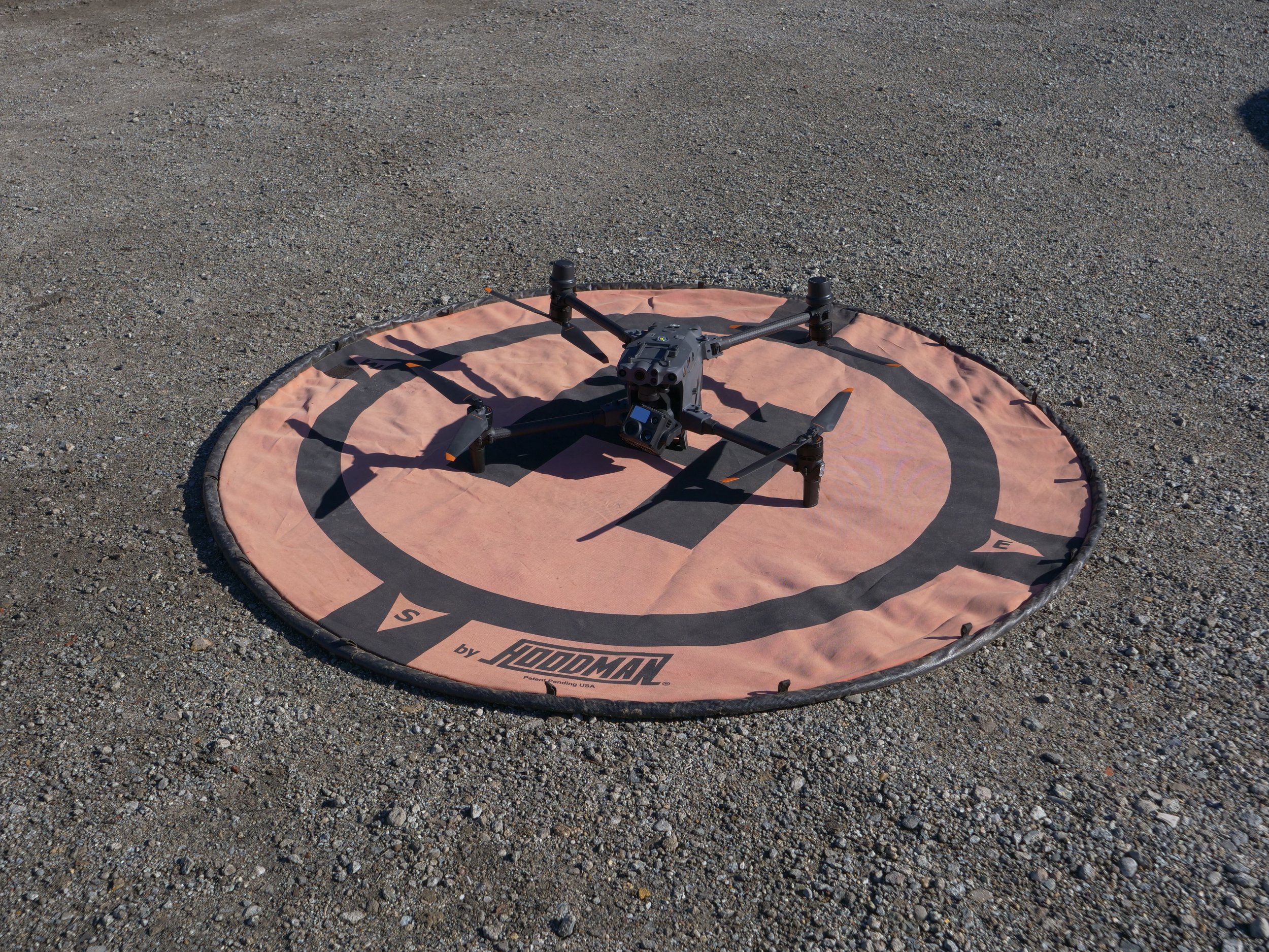 Drone rests on landing pad.