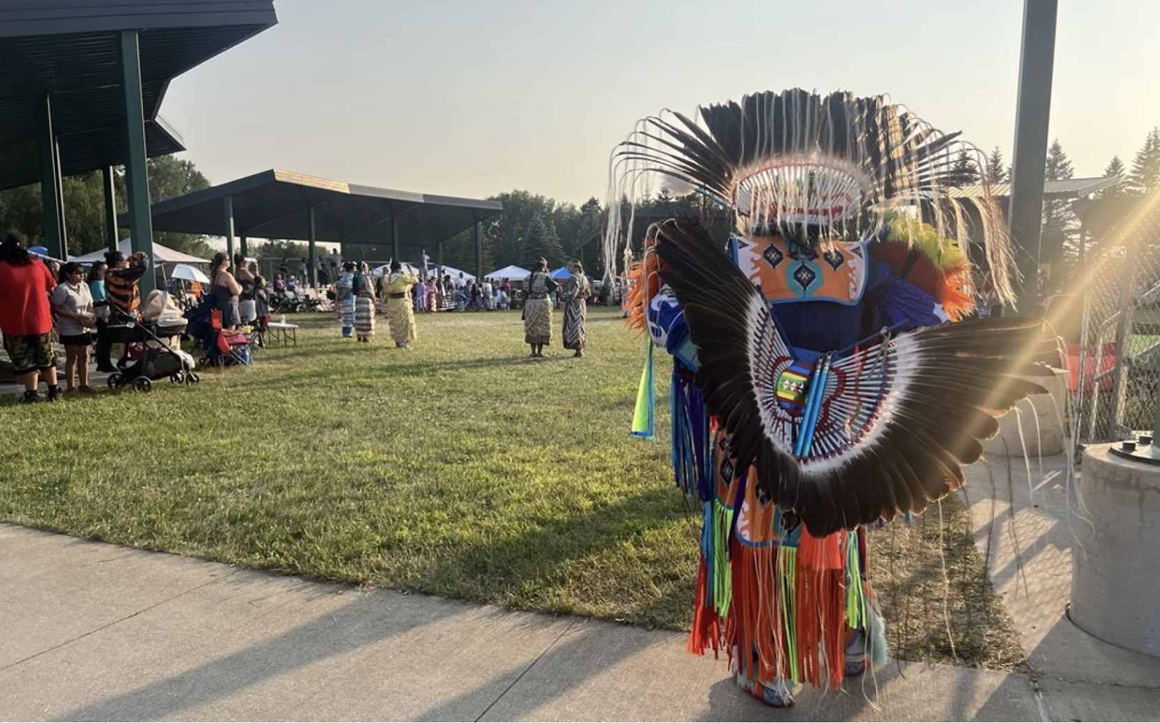 A dancer looks into the arena at the Gii-Ishkonigewag Pow Wow on July 25, 2026, in McGregor.