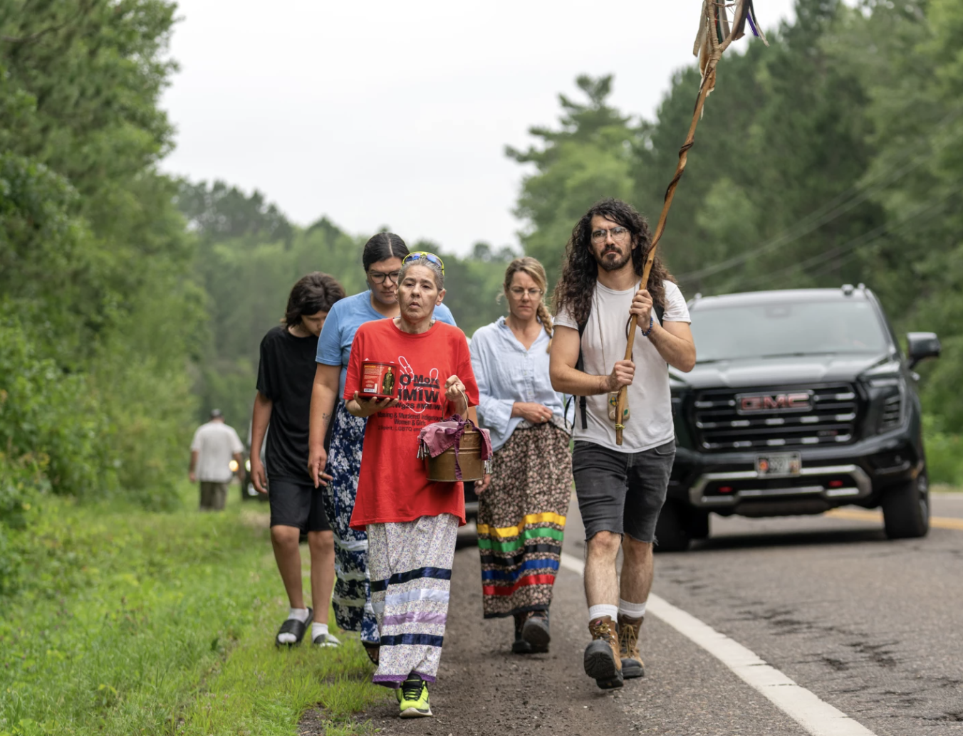 Sherry Couture carries water and walks with other participants during a water ceremony and walk in McGregor on July 25, 2026. Photo by Lorie Shaull / KAXE.