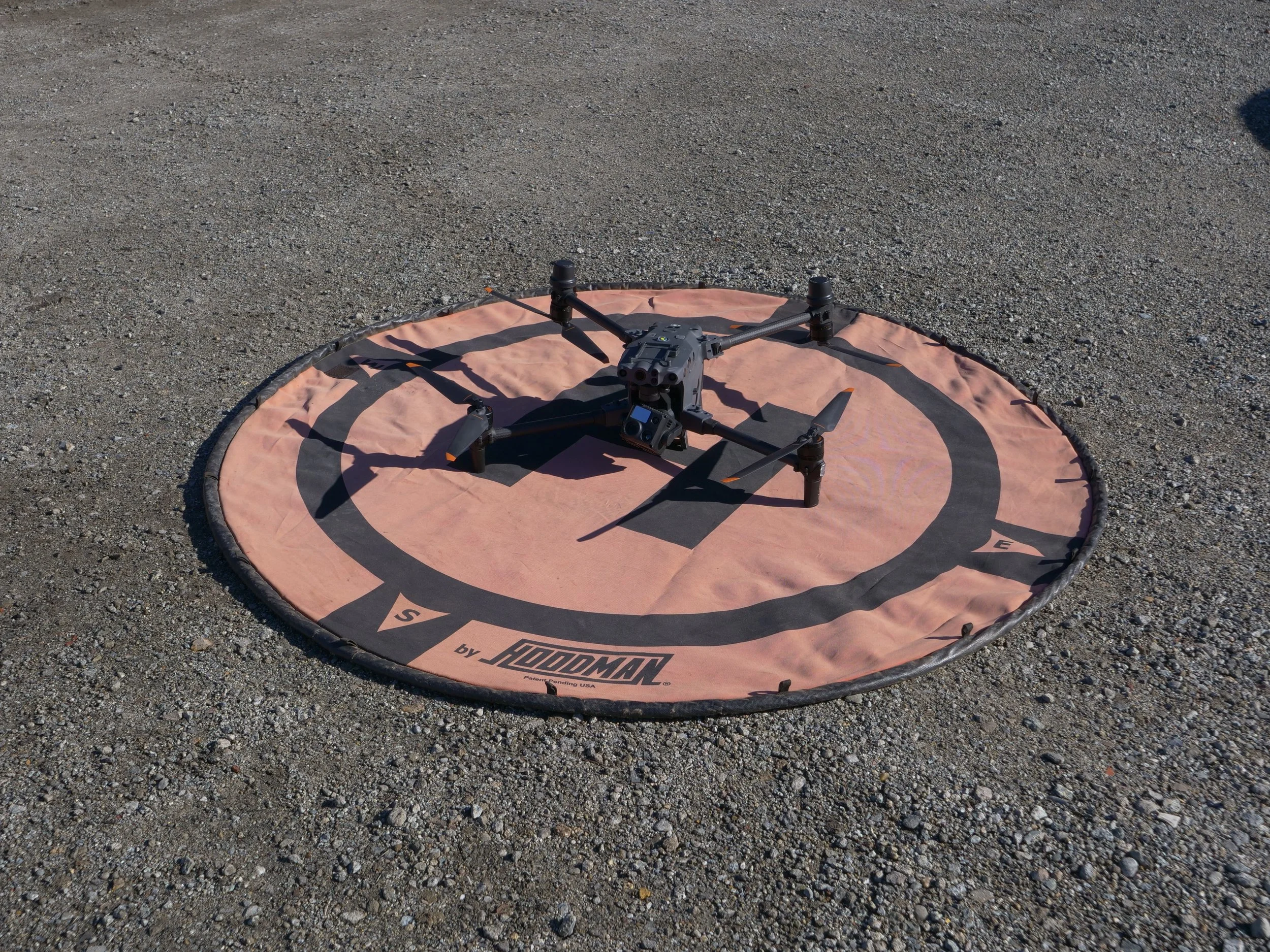 Drone resting on a landing pad.