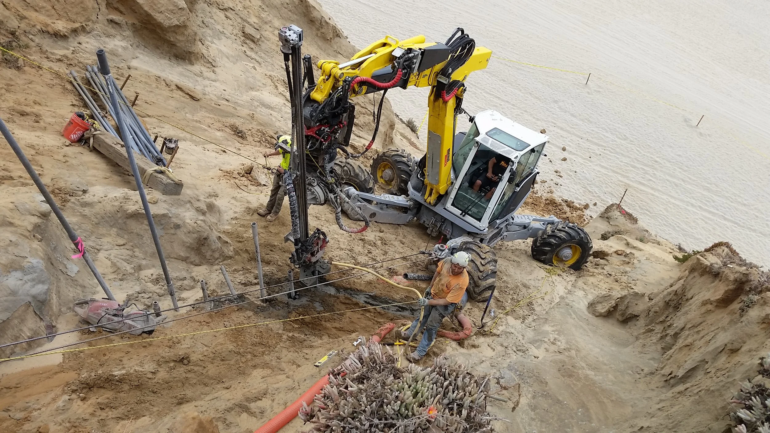 Drill Rig on a coastal bluff performing micropile installation during upper-bluff stabilization