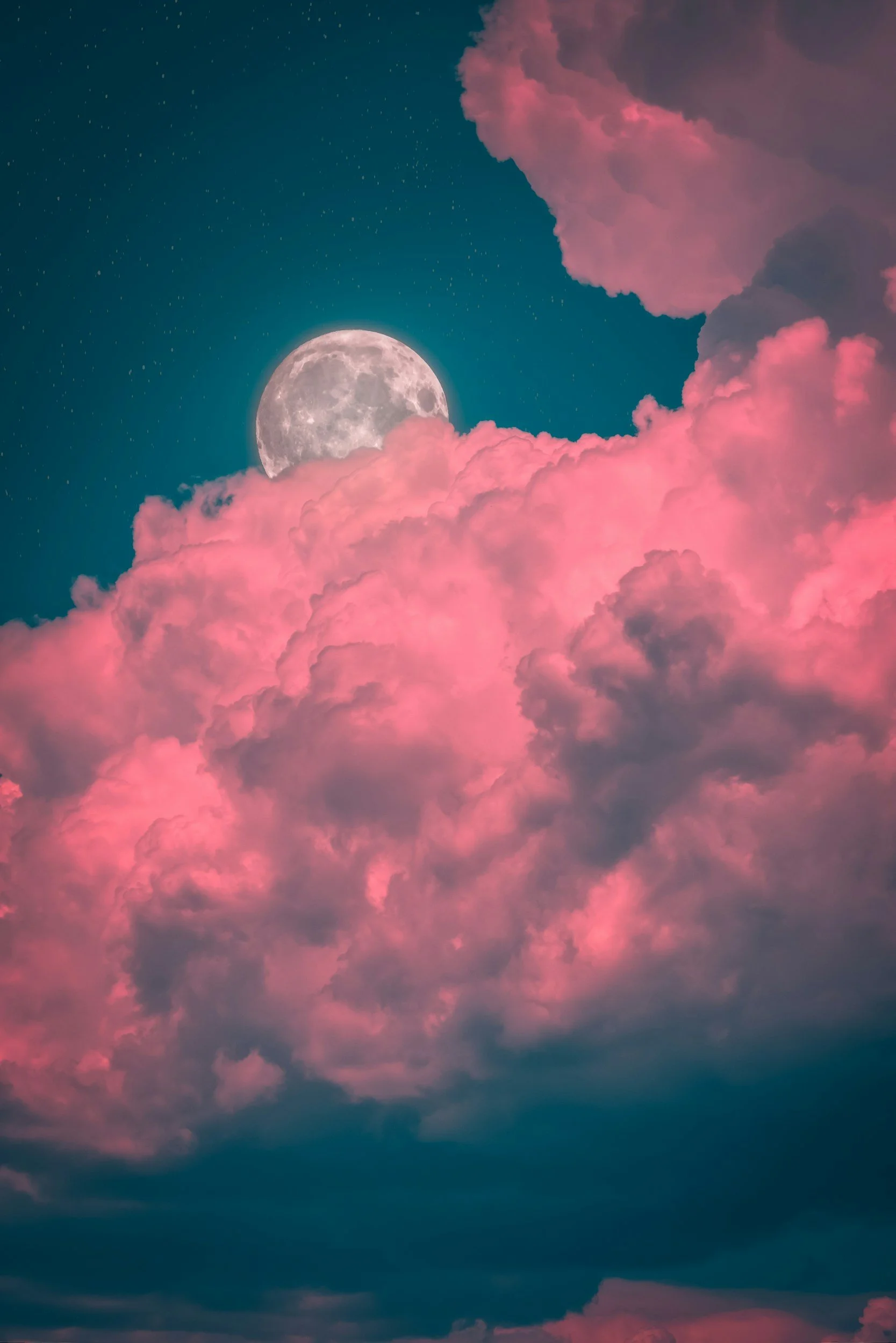 Full moon behind pink clouds, representing feminine business growth.