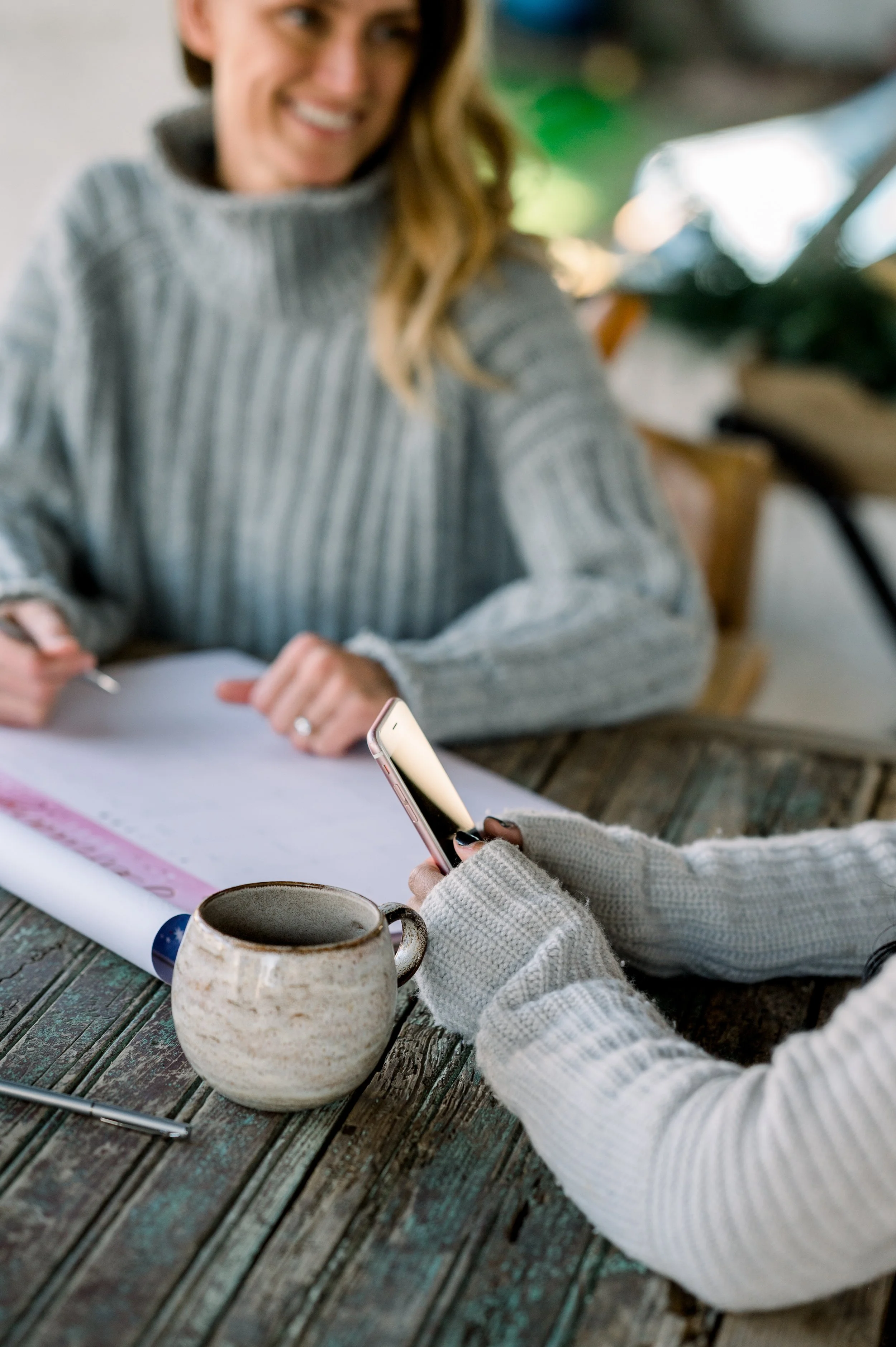 Home-Office with women working at table with coffee and planners, representing productive collaboration in messaging clarity.