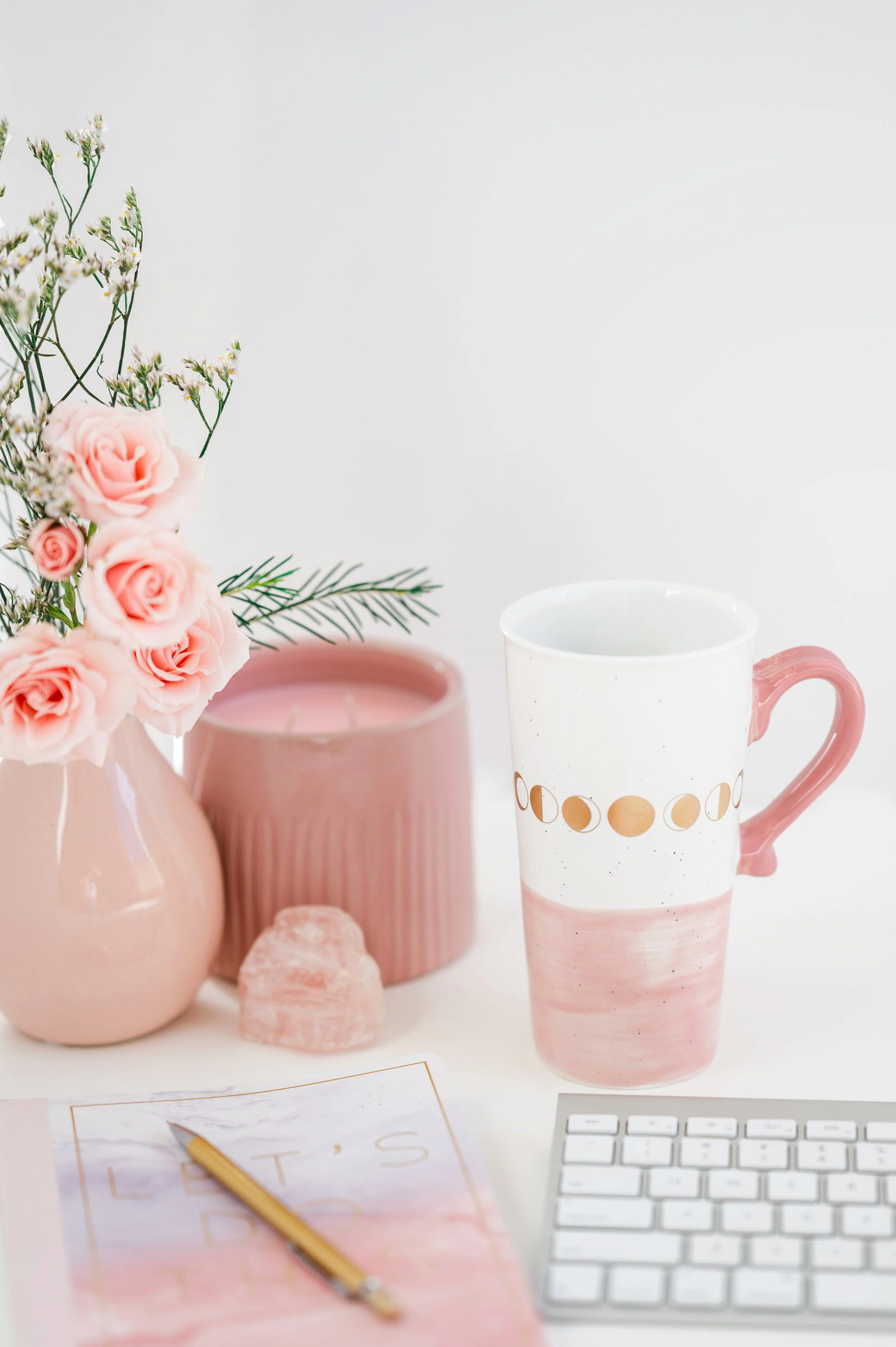 Pretty Pink Workspace with coffee cups and flowers, representing a calm workflow.