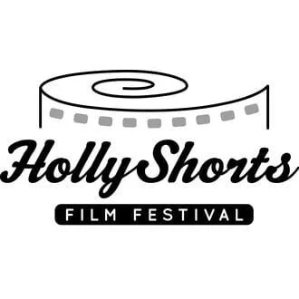 Logo for HollyShorts Film Festival featuring a rolled film reel with the festival name written below.