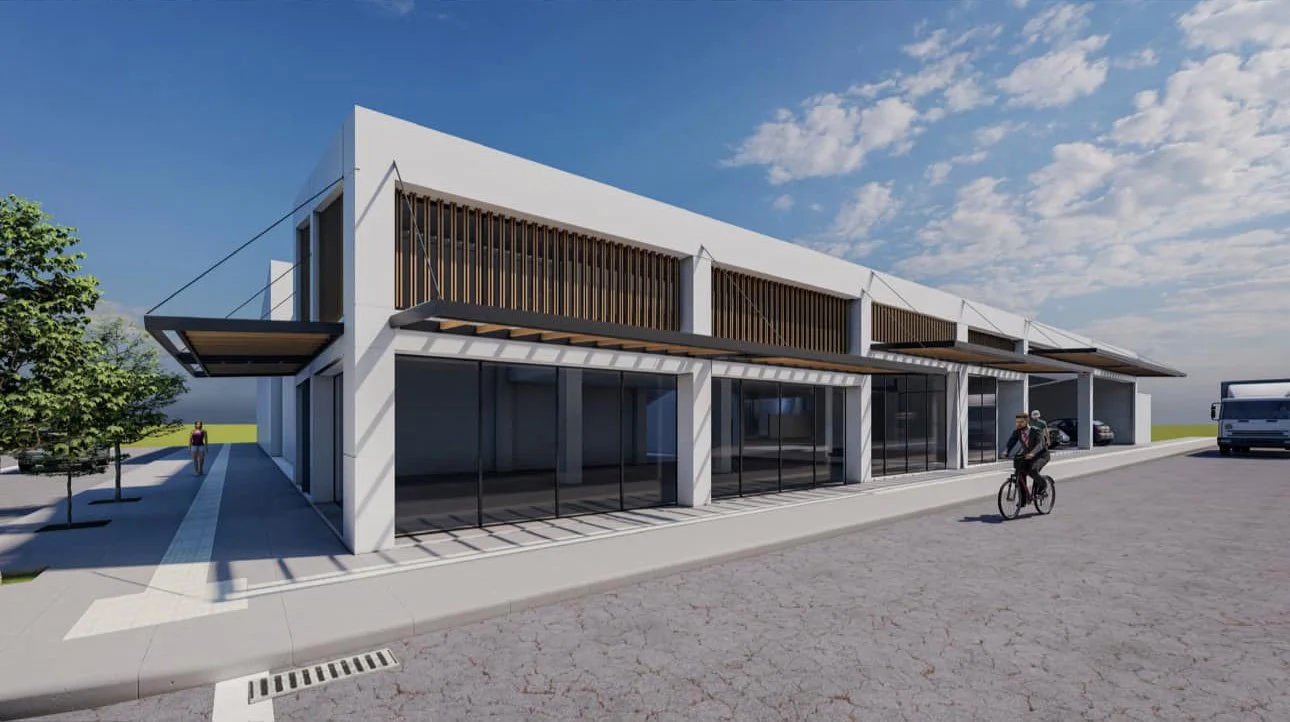 Edificio moderno de dos pisos con fachada de vidrio y persianas de madera, ubicado en una calle con ciclista, peatones y un camión estacionado. Cielo parcialmente nublado.
