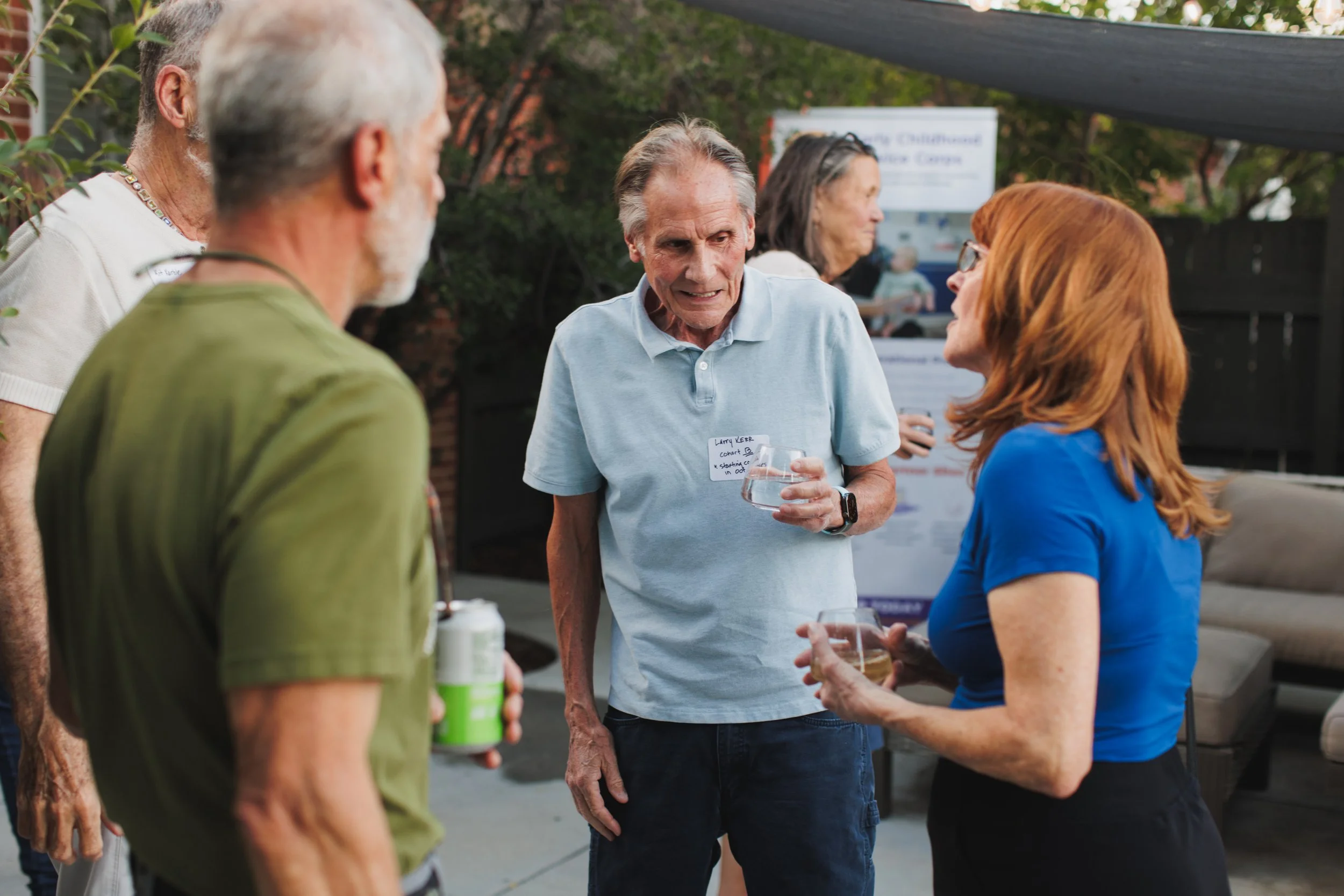 an older adult who is training to teach early childhood mingles at a colorado event