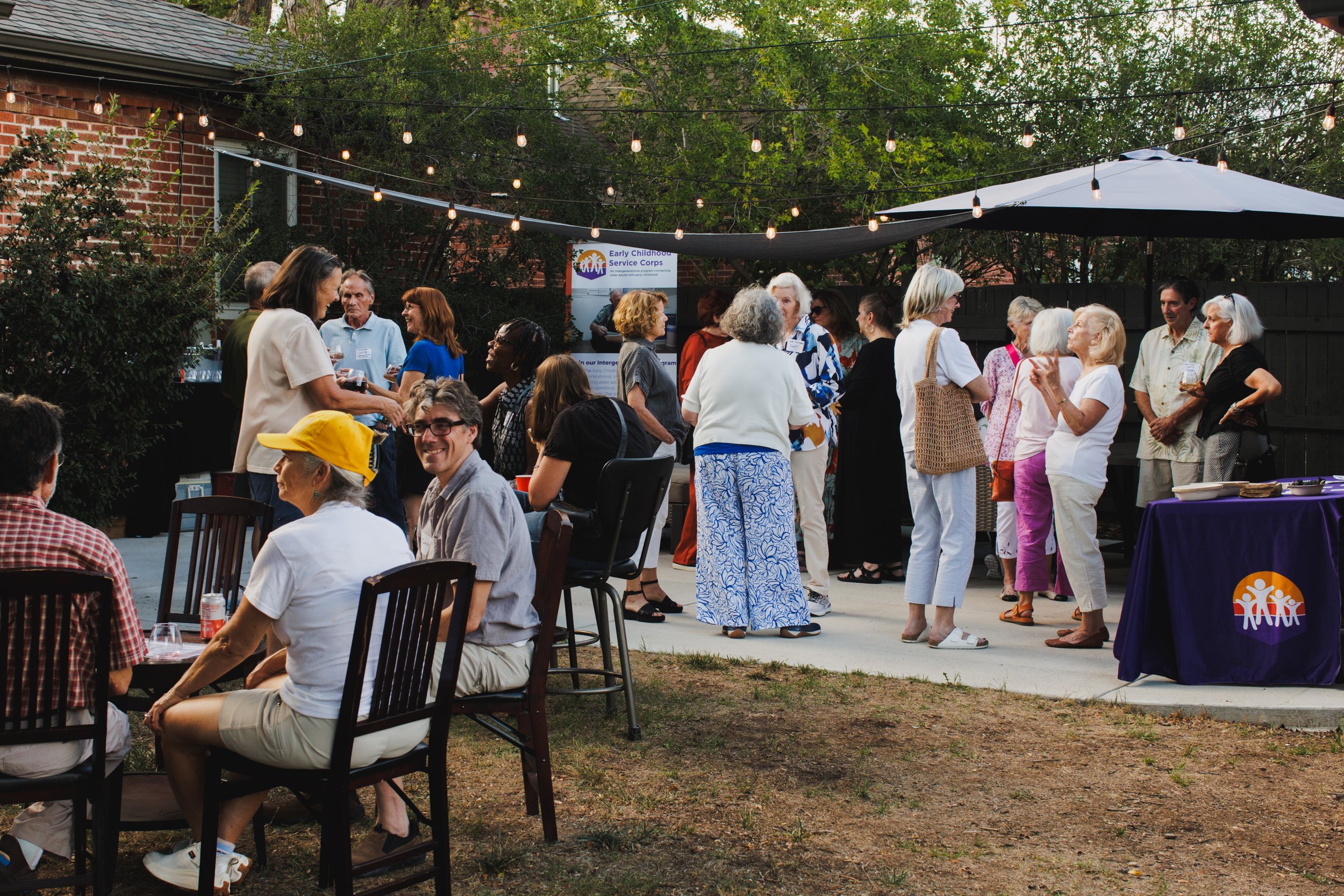 Retirees over 50 who teach or volunteer in early childhood education gather in a Denver Colorado backyard