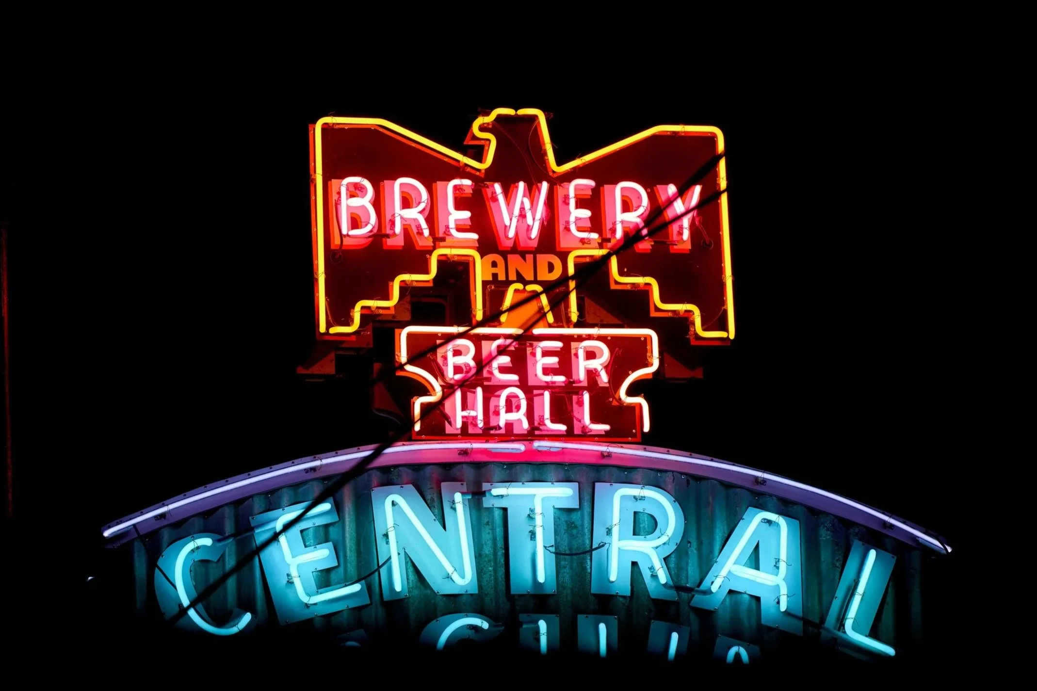 Colorful neon sign reading 'BREWERY AND BEER HALL' against a dark background.
