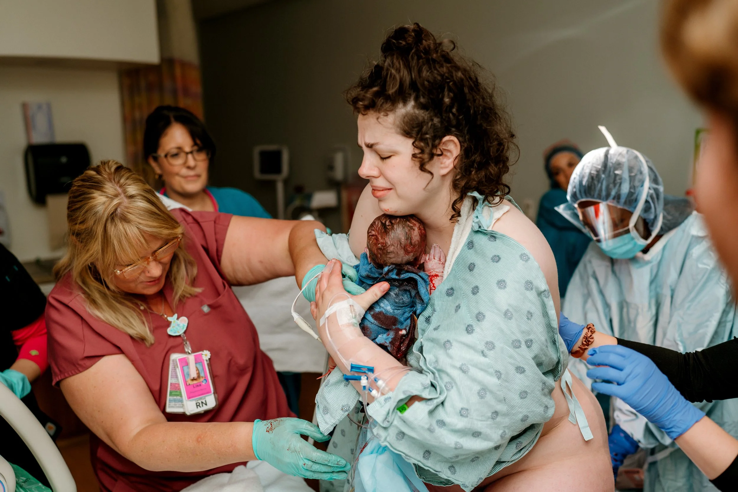 Mom holding her baby for the first time after birth in hospital in the Woodlands, Tx captured by Vanessa Tobias Photo