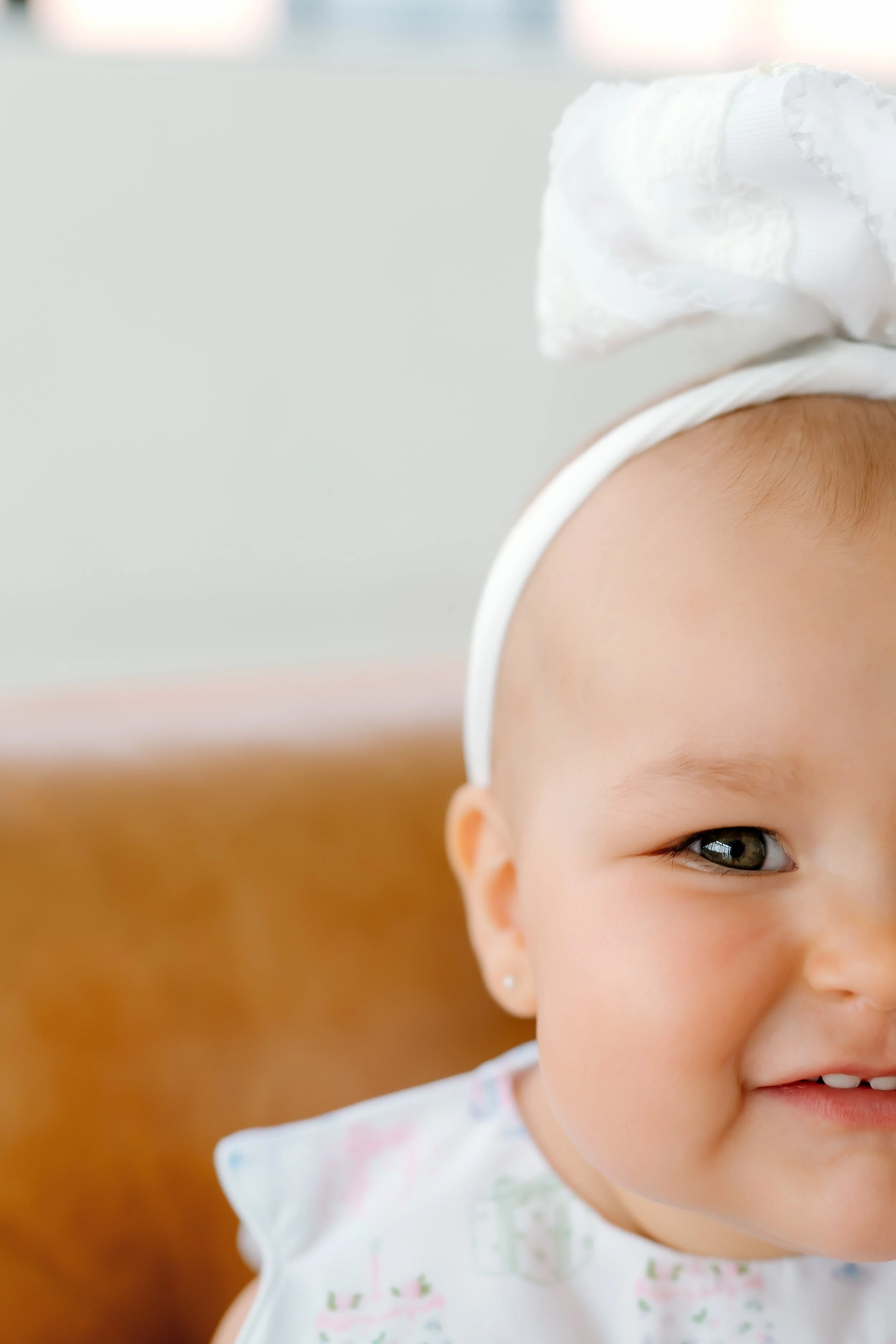 Close-up portrait of a smiling baby during a milestone photography session in The Woodlands, TX