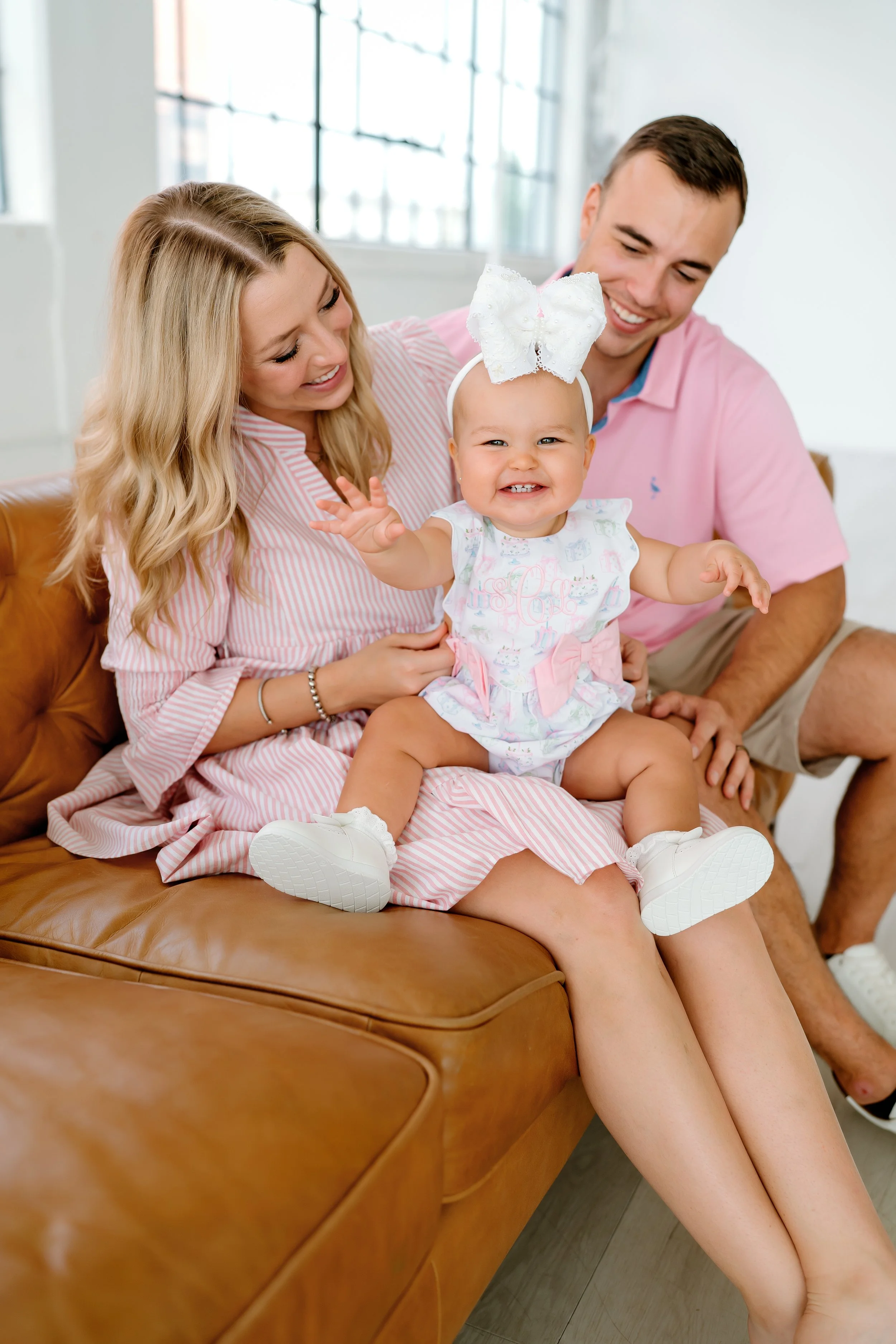 Family celebrating their baby's first birthday during a family photography session in The Woodlands, TX