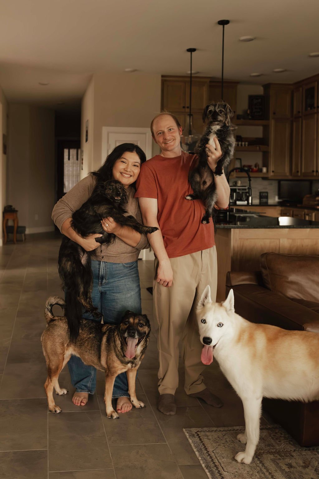 Vanessa Tobias with her husband and their dogs at home