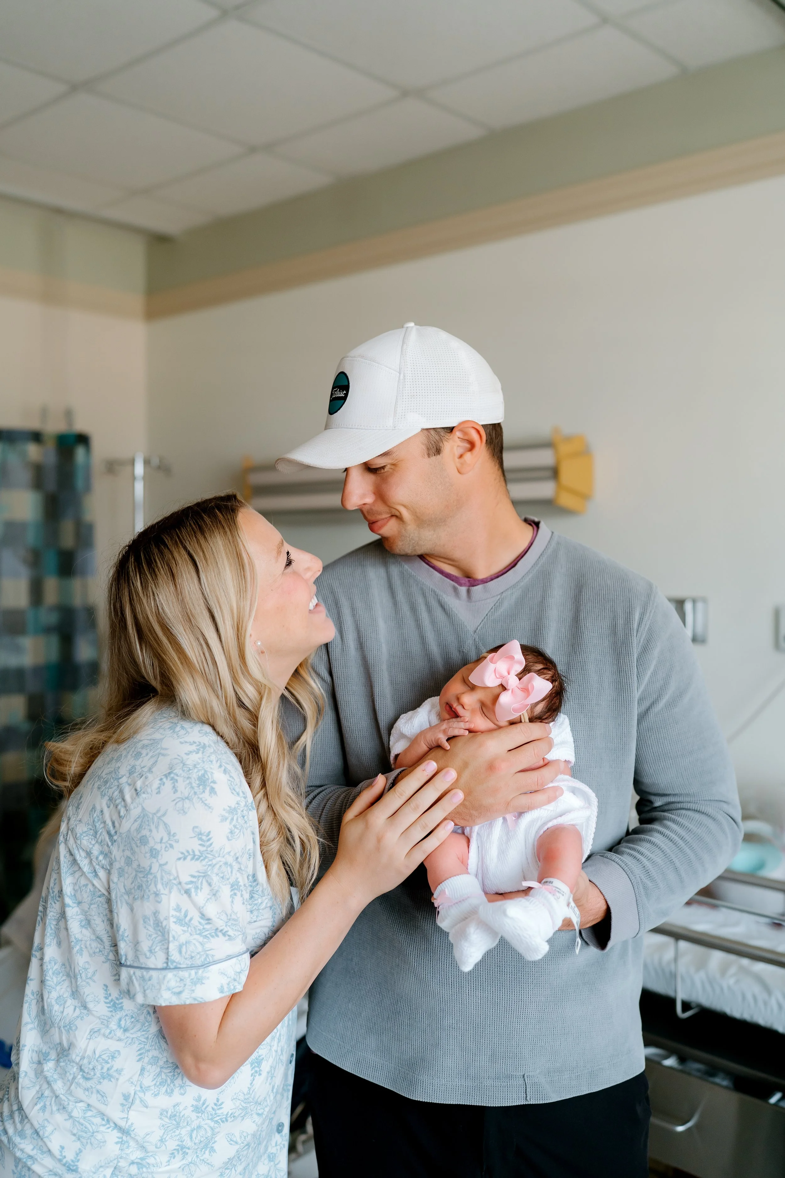 Father holding newborn at a hospital in The Woodlands, Texas.