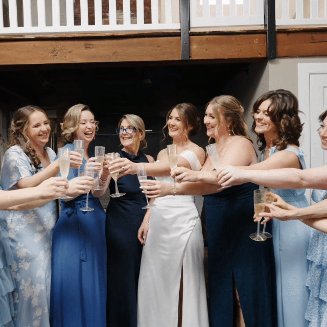 Jewish Wedding Celebration. wedding video by Lasting Legacy Films. Group of women in dresses celebrating with champagne at a wedding reception. Wedding Venue in Massachussets. 