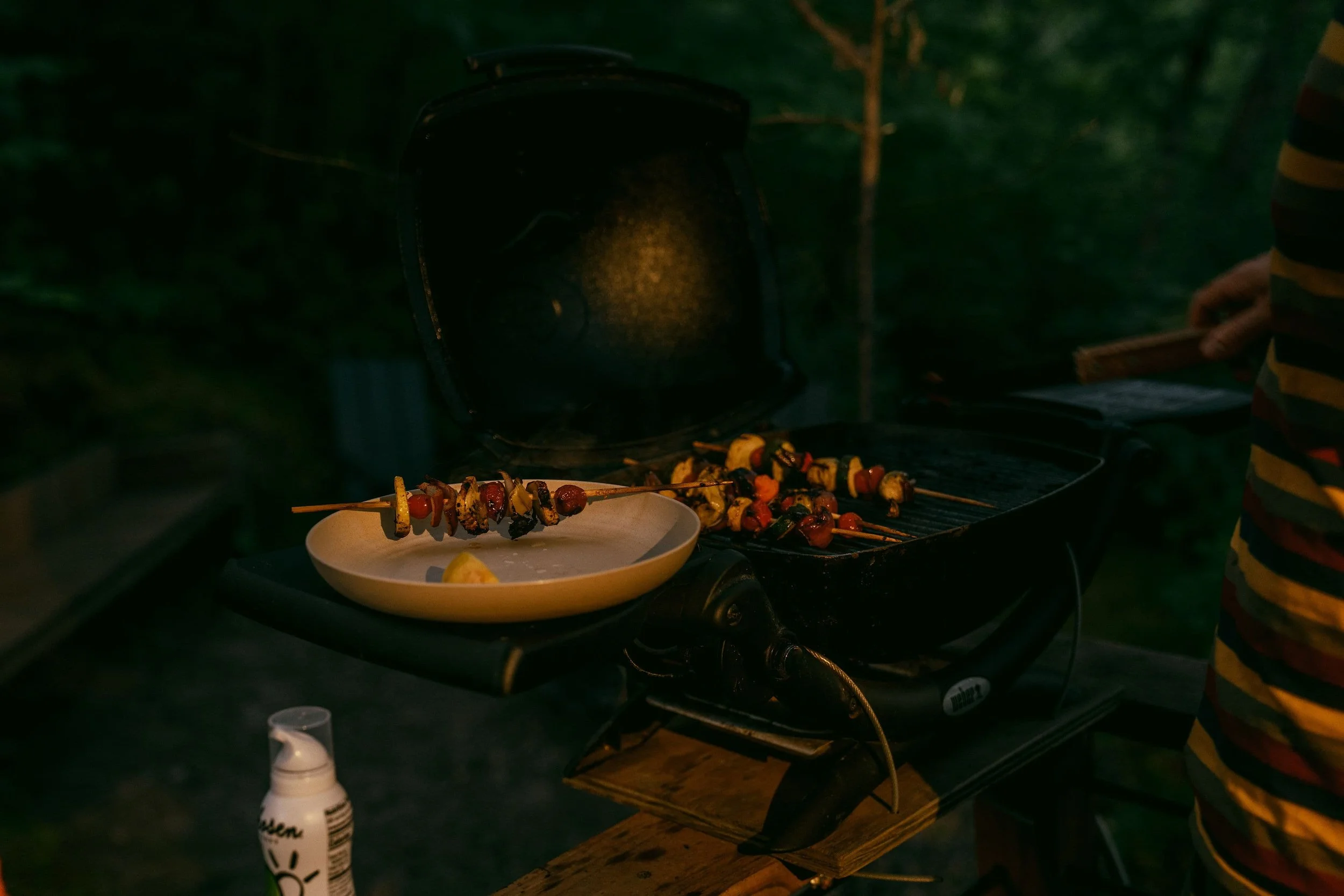 Person walking a mountain bike with a coffee cup