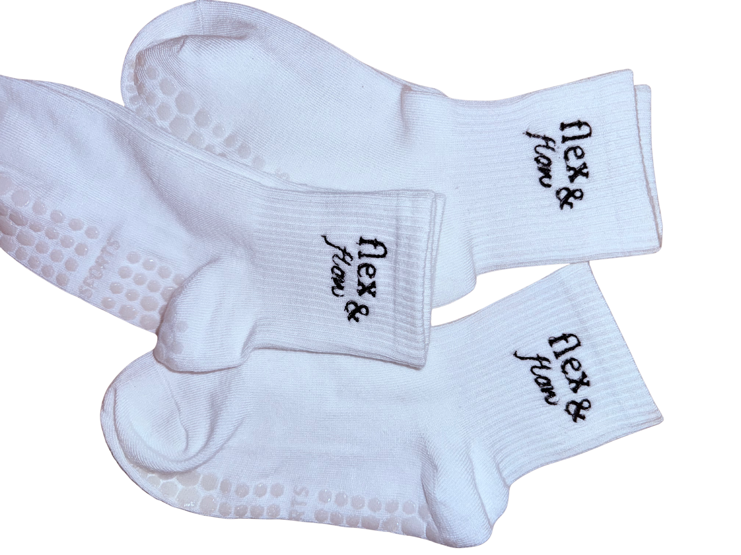 Pair of white crew socks with black embroidery that says 'relax & have fun'.