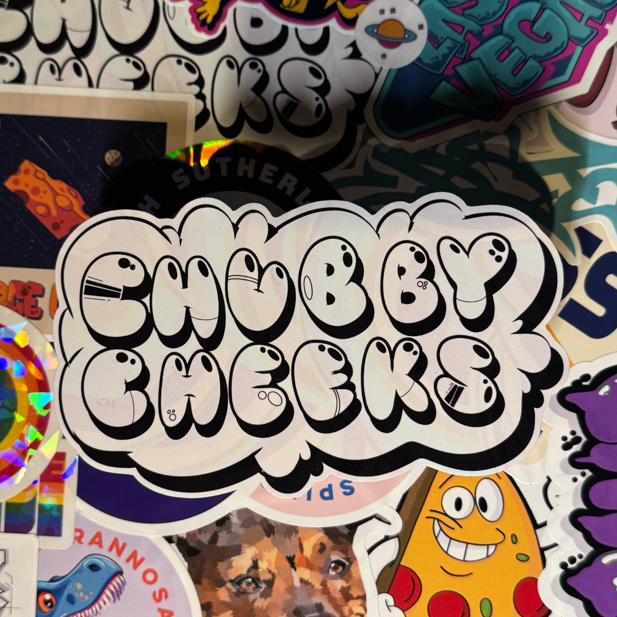 photo of hand-made sticker to show quality of the word chubby cheeks done with transparent rainbow colors in graffiti style