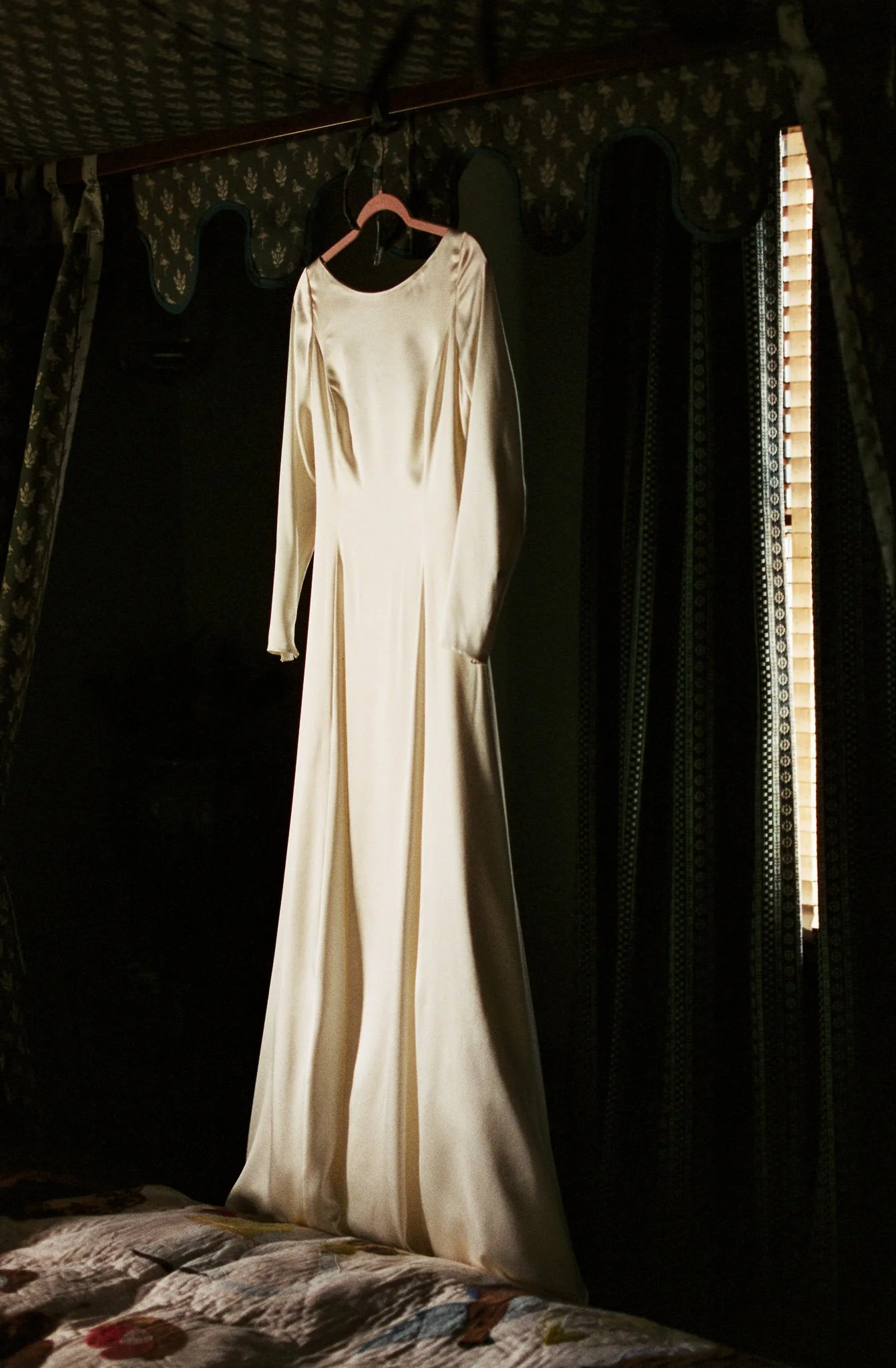 beautiful classic bridal gown hanging on wall