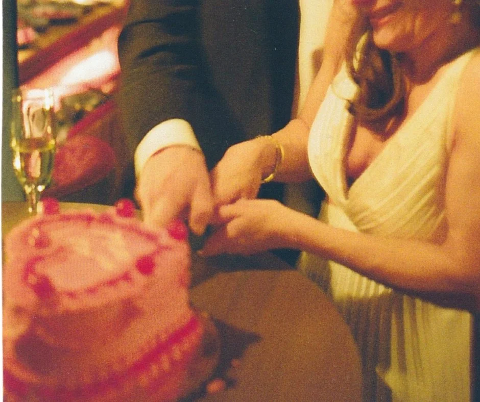 film artistic inspired photo of couple cutting cake at their wedding