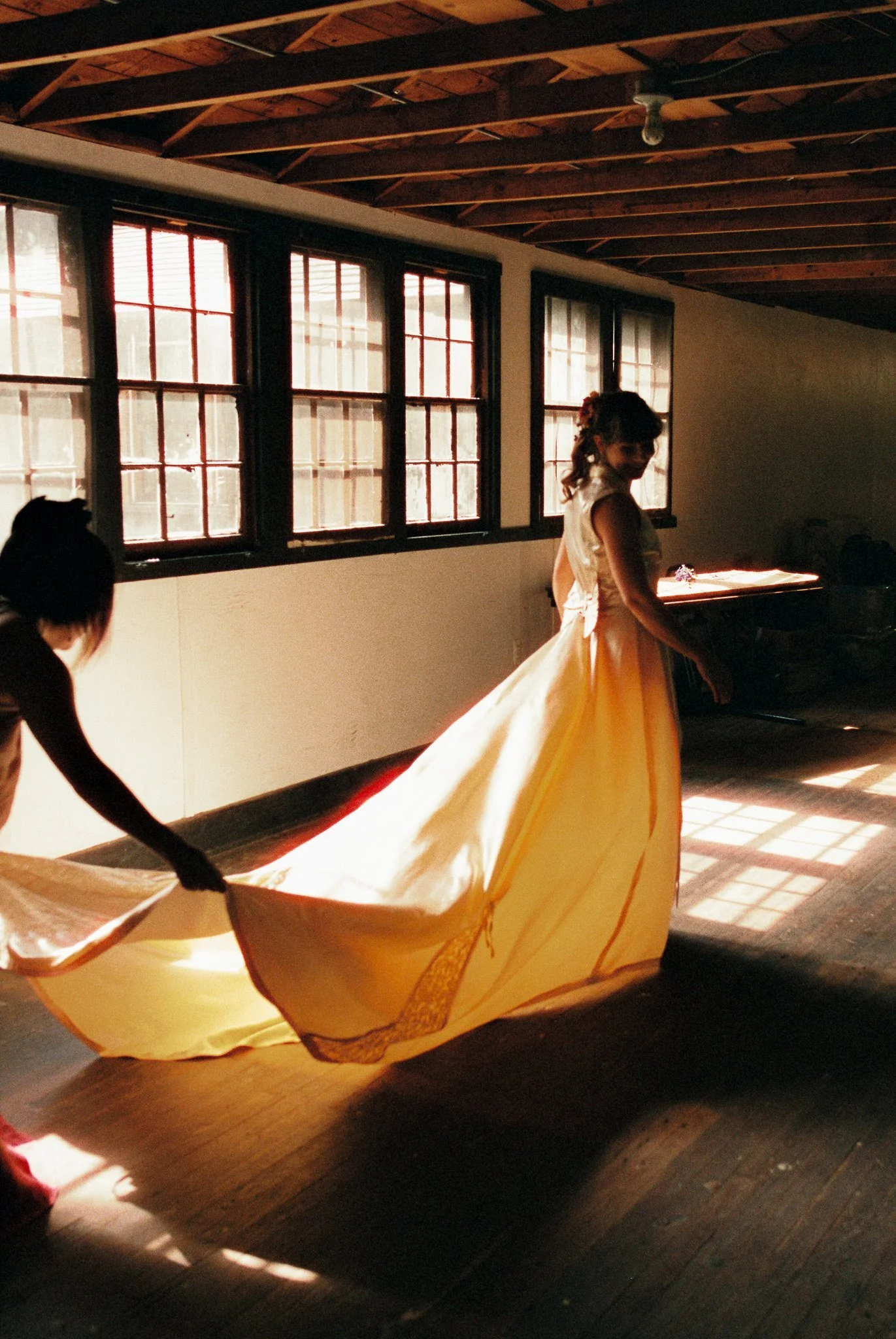bride in sun lit room with beautiful gown