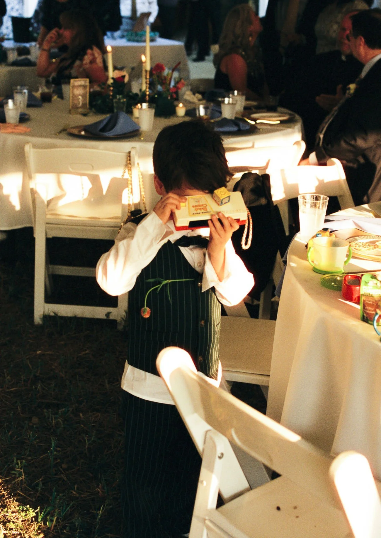 kid taking photo at reception 