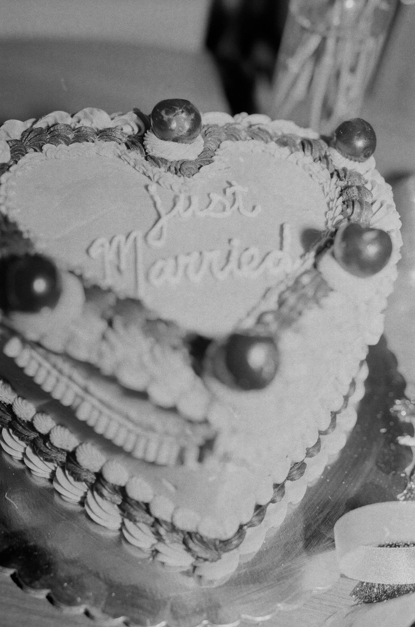 black and white photo of wedding just married cake heart shaped