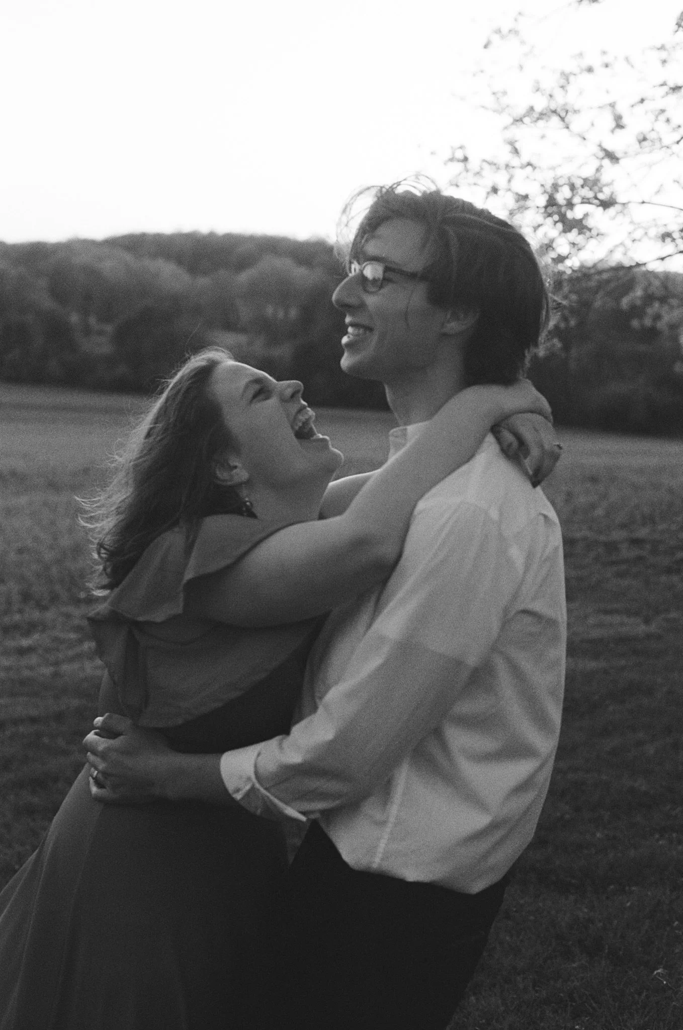 candid moment of couple hugging and laughing