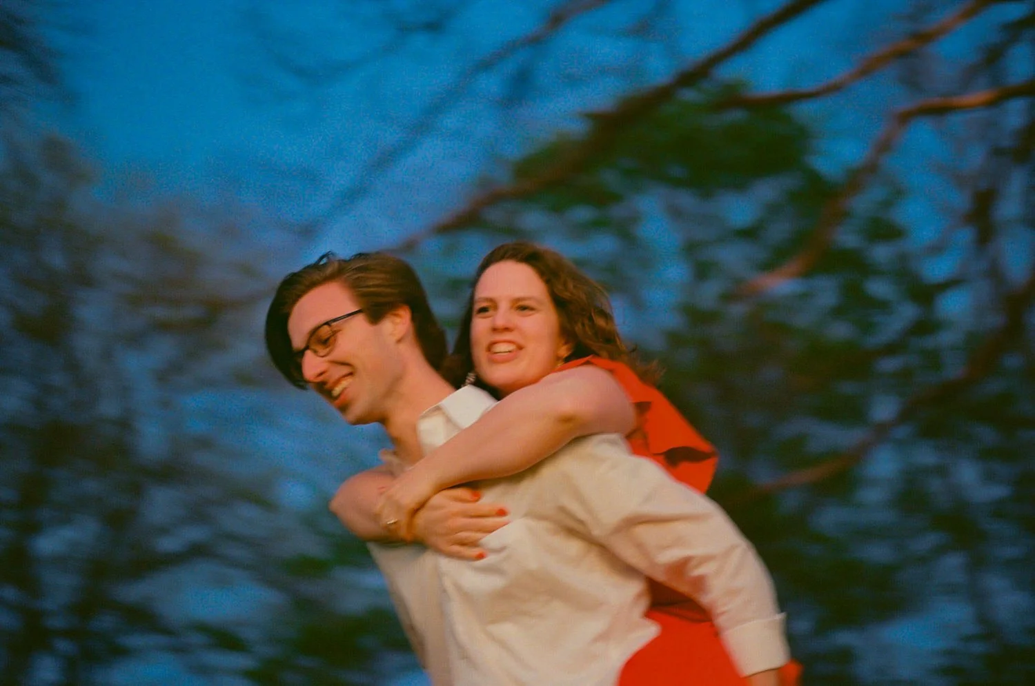 piggyback style photo with greenery and blue skies