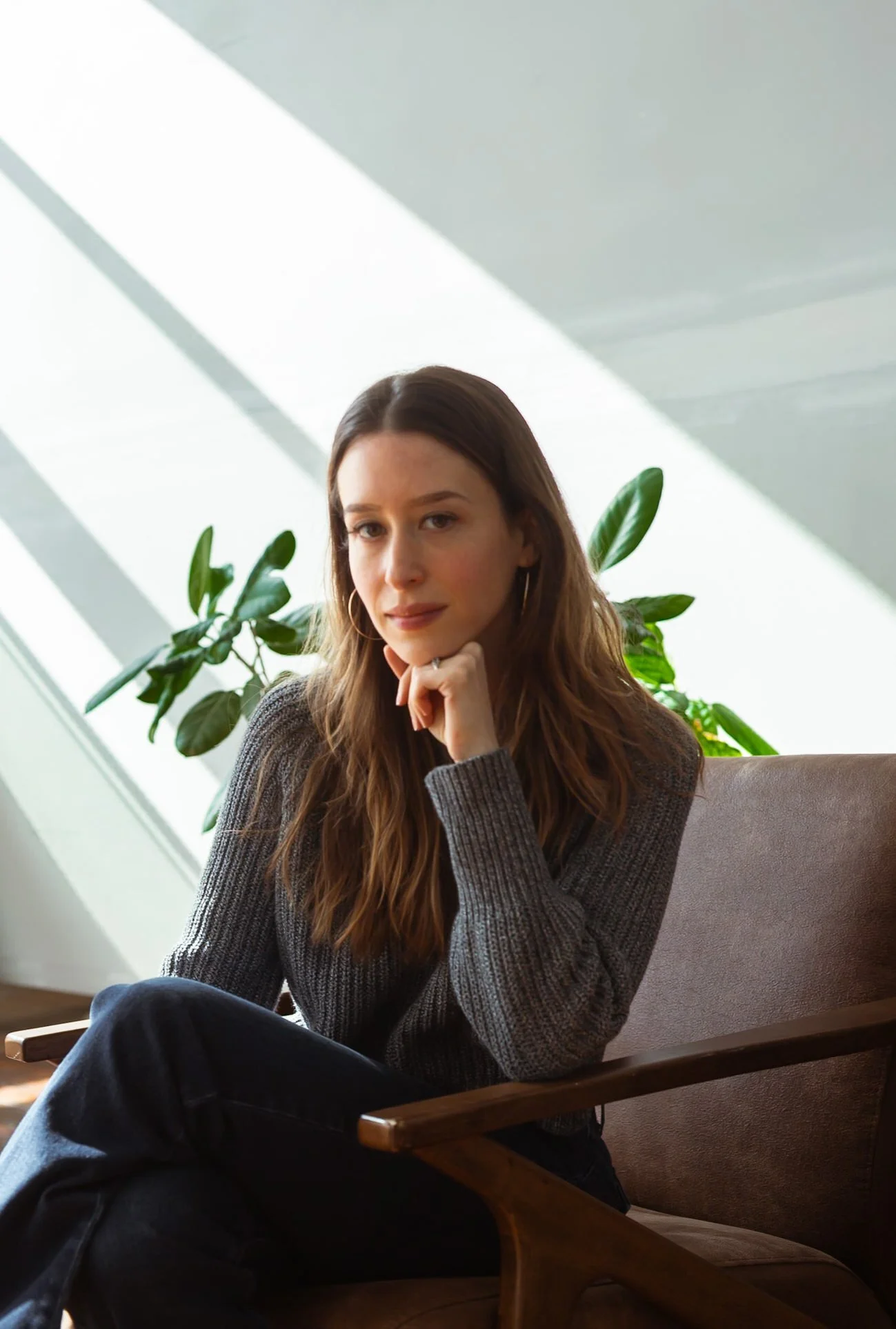 woman sitting in chair sunlit studio portrait session